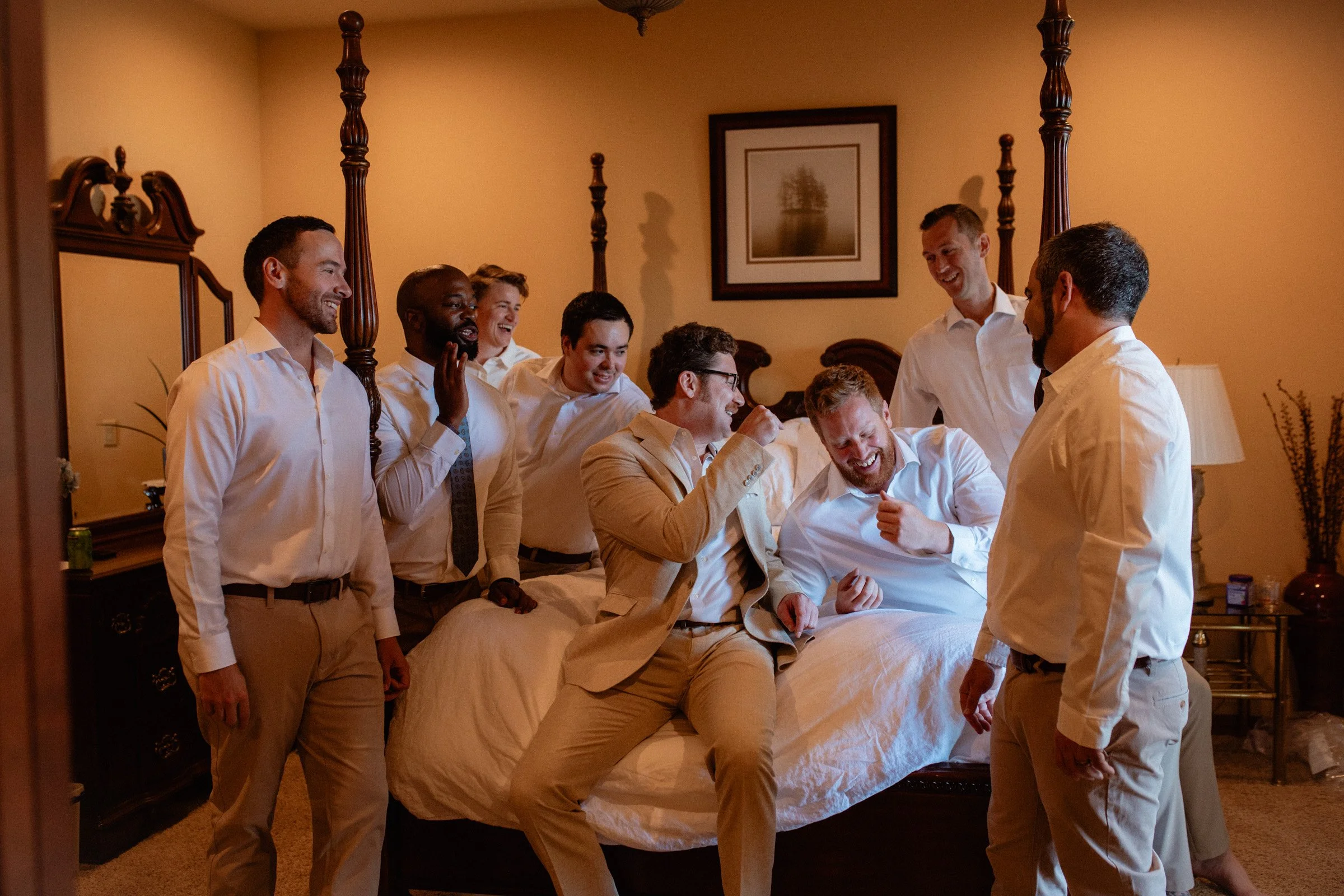 Groomsmen celebrating with the groom in the getting ready suite before the wedding at an AirBnb in Spanaway, WA