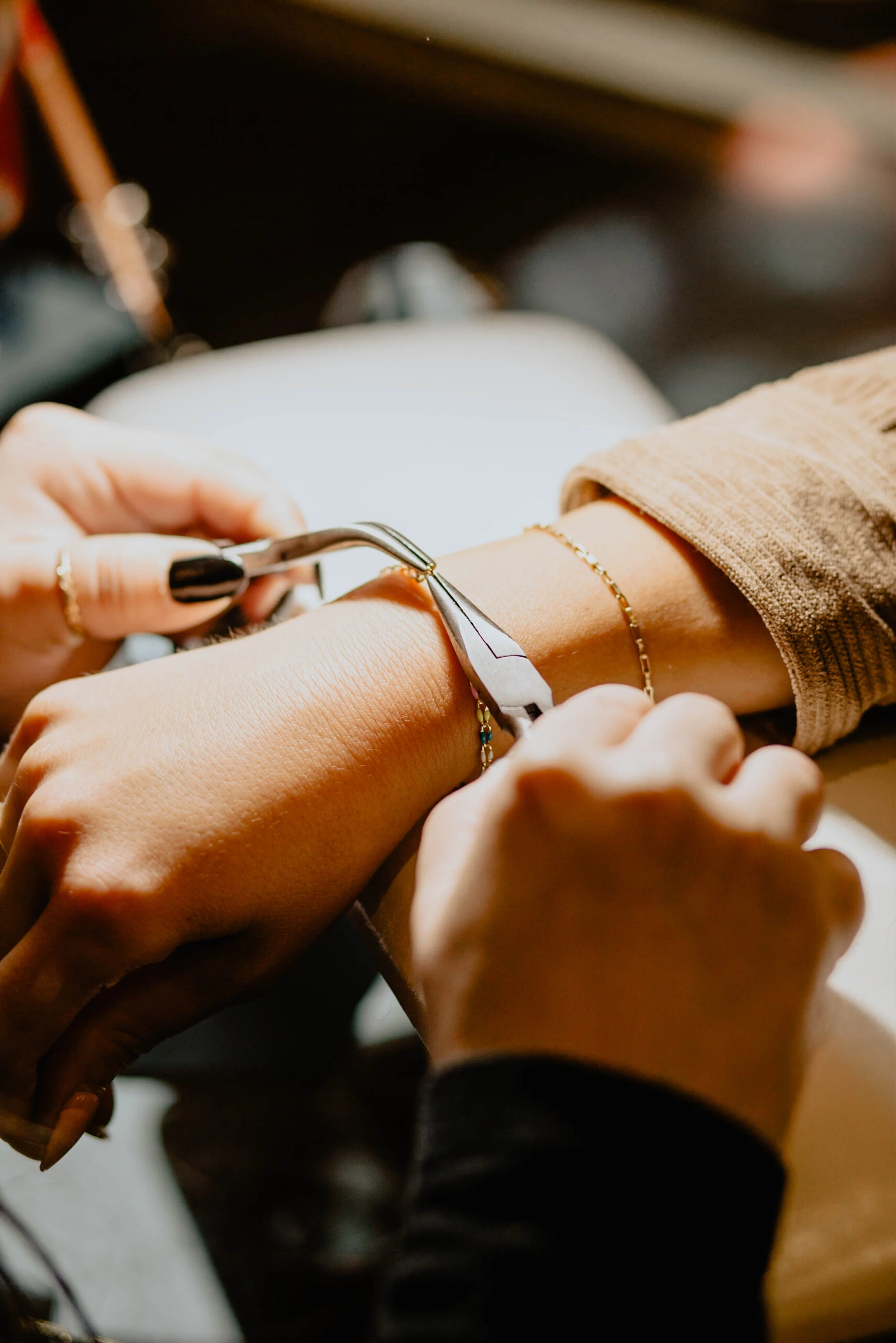 A person is receiving a manicure, using a nail tool on their fingernails. Seattle professional head shot photography
