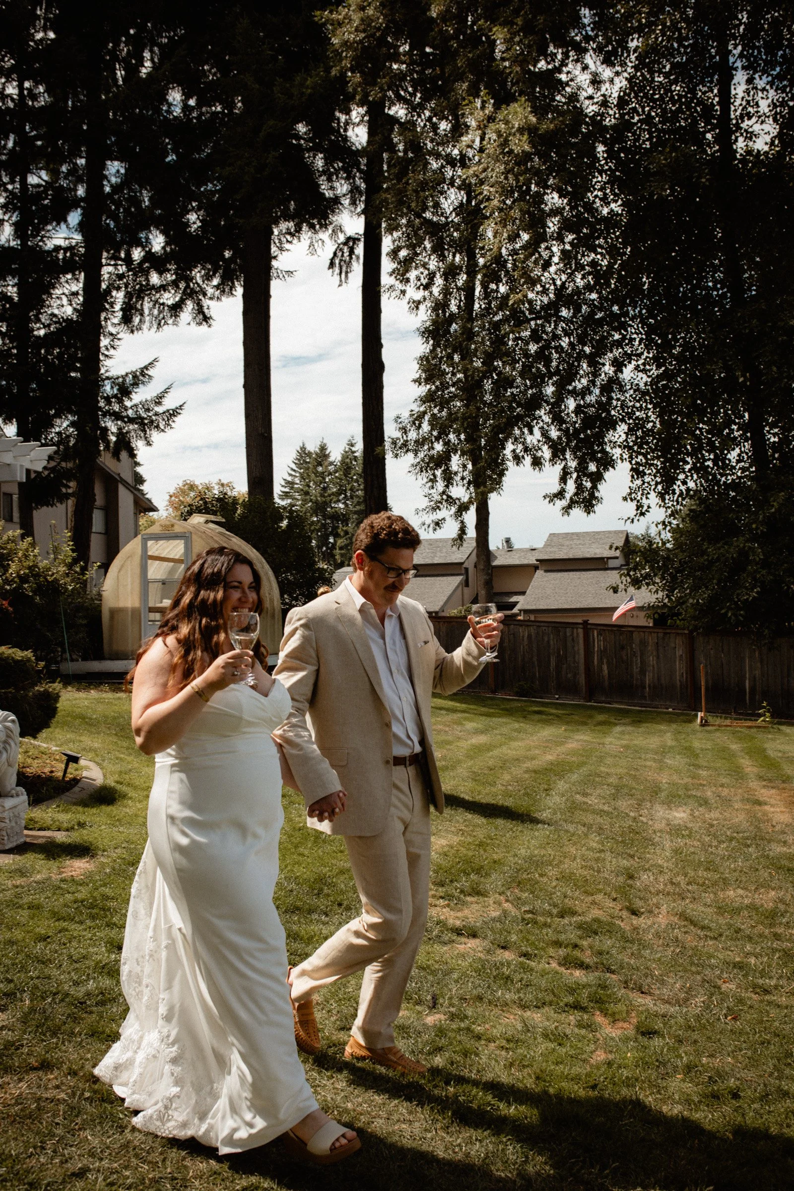 Bride and groom walking into their wedding reception being introduced for the first time as husband and wife at their lakeside wedding in Seattle, WA