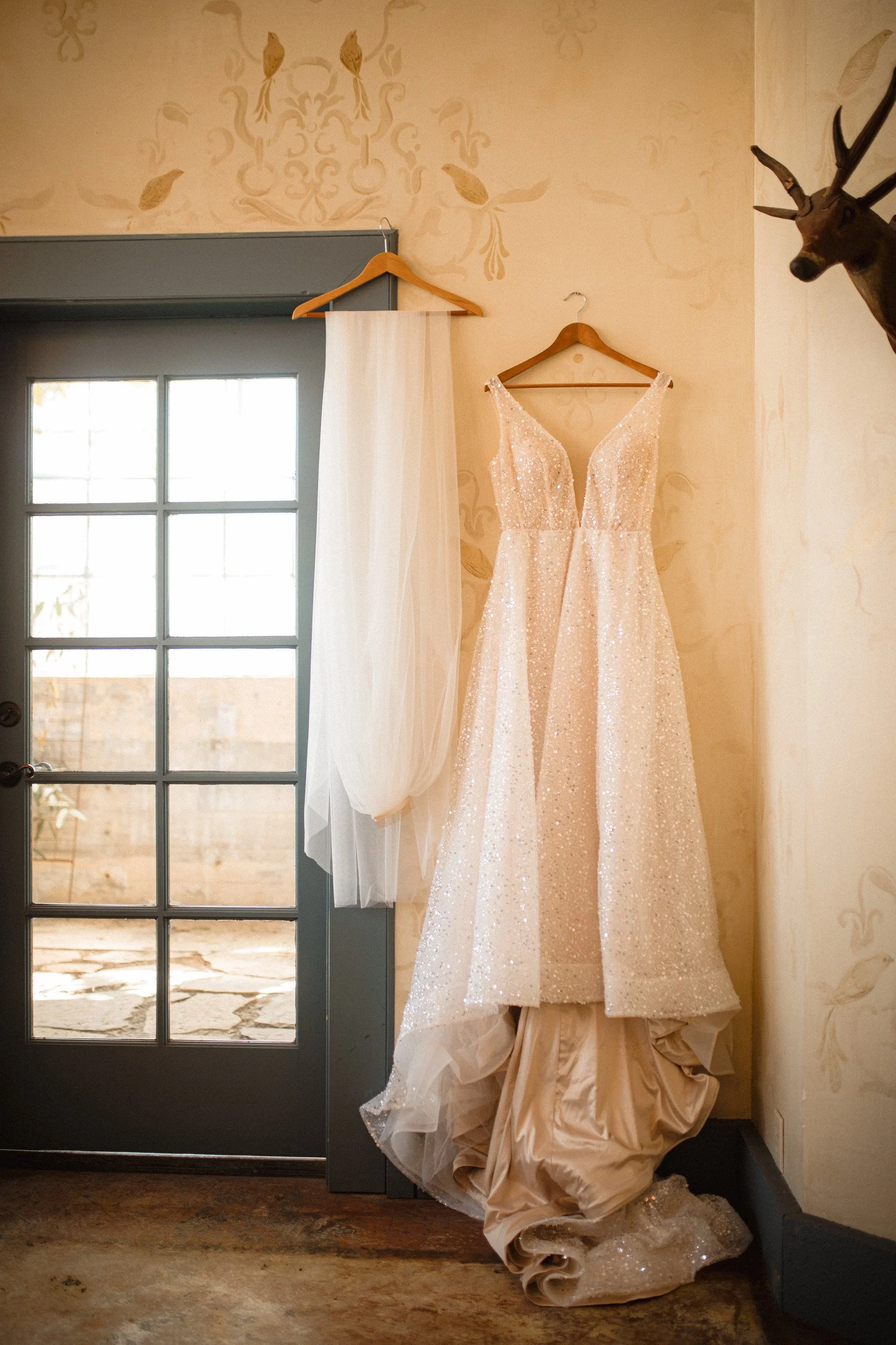 Wedding gown hanging in the bridal suite at The Ruins wedding venue in Queen Anne, Seattle