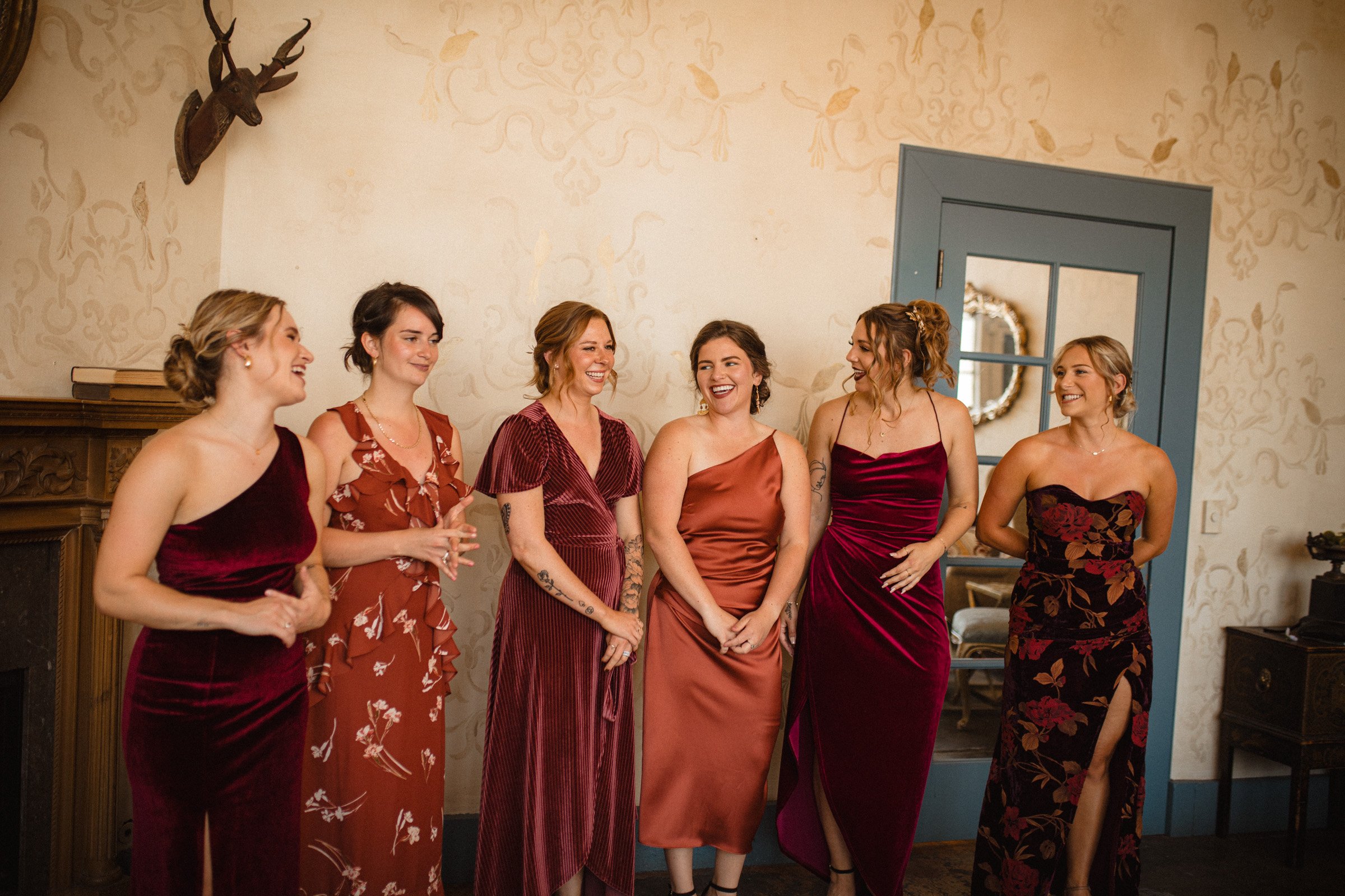 Bridesmaid wait in anticipation for the bride to reveal herself in her dress in the bridal suit. The Ruins Queen Anne, Seattle