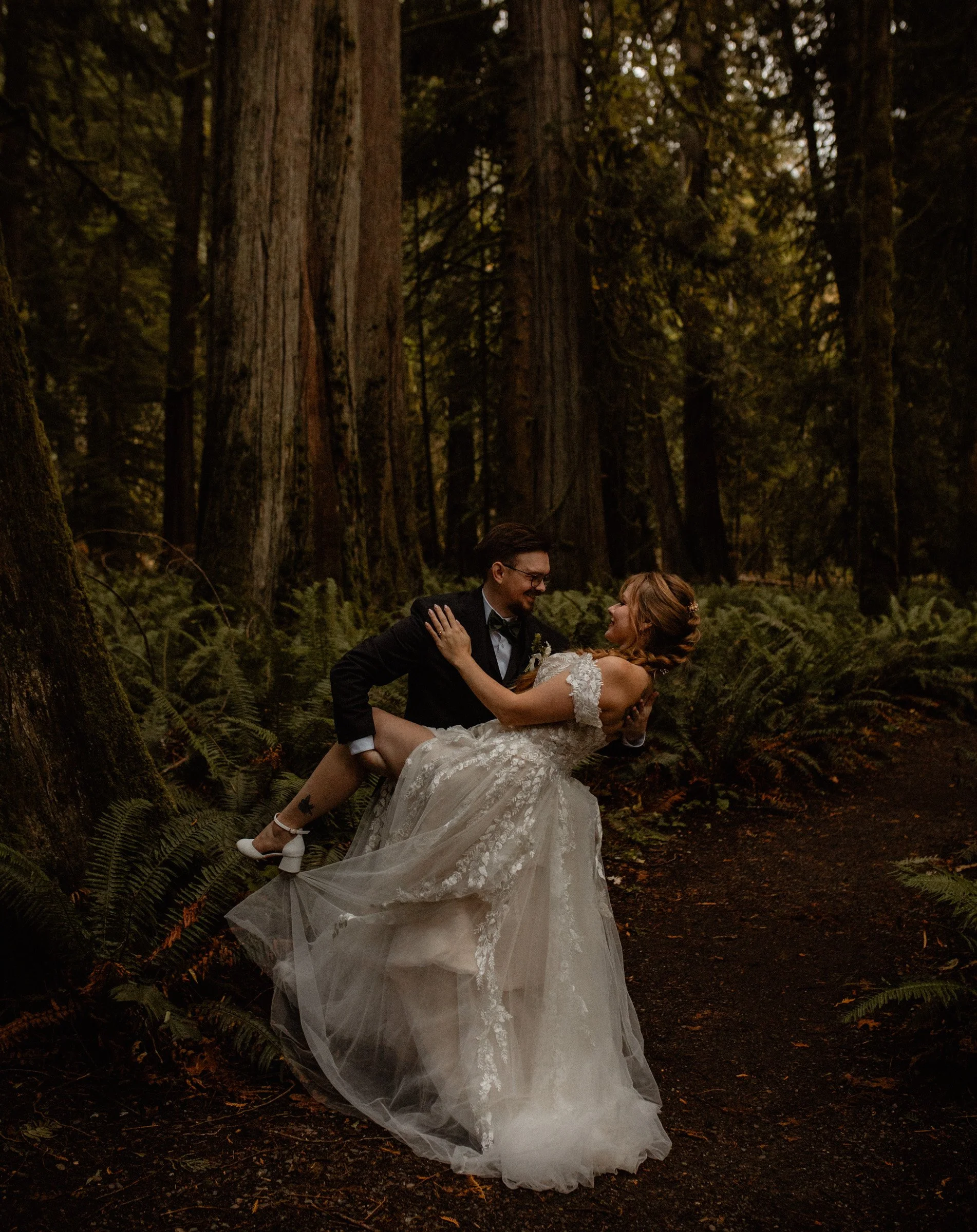 Bride and groom sharing a quiet moment surrounded by tall trees in a forest near Lake Crescent Lodge.