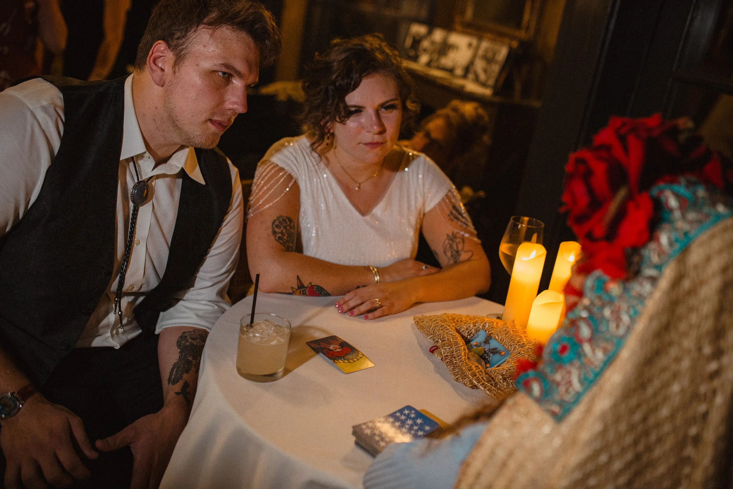 Bride and groom get a tarot card reading done during their wedding recpetion at The Ruins in Queen Anne, Seattle