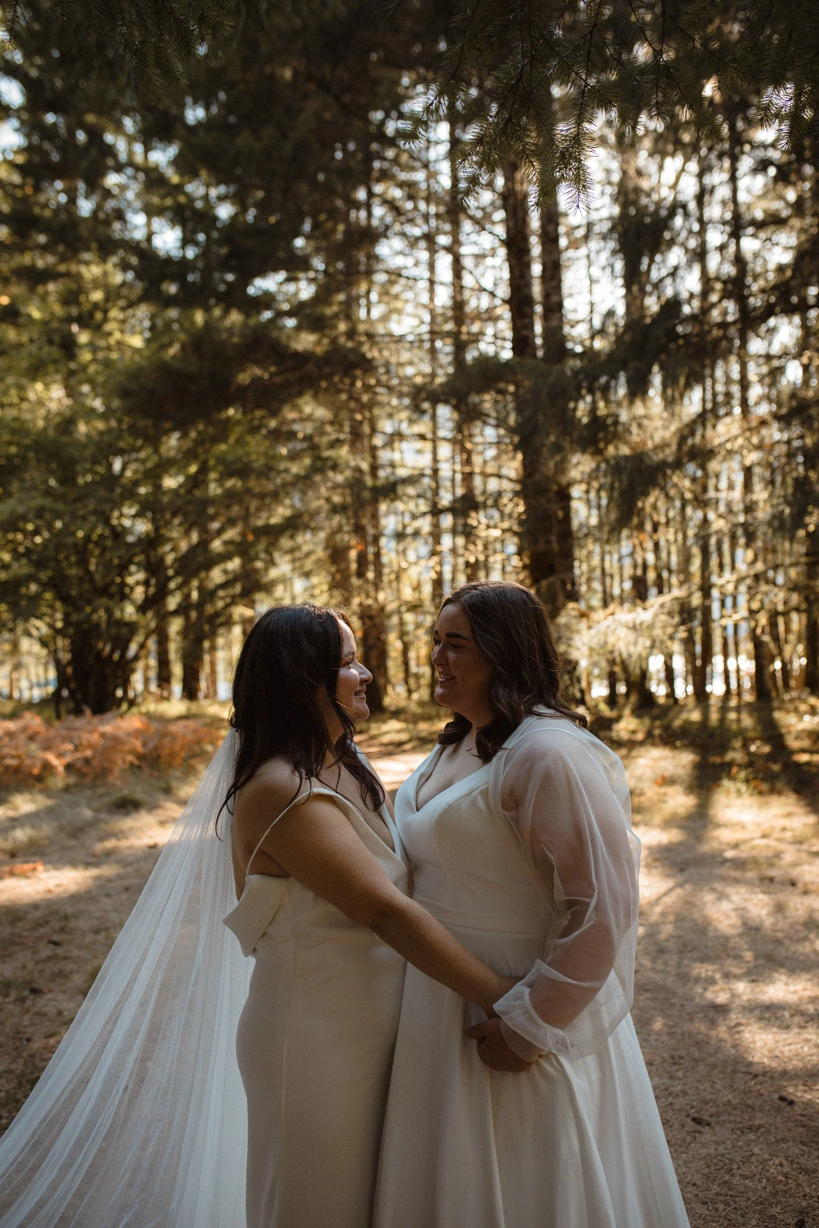 Two brides posing together during wedding portraits in Port Angeles, Washington