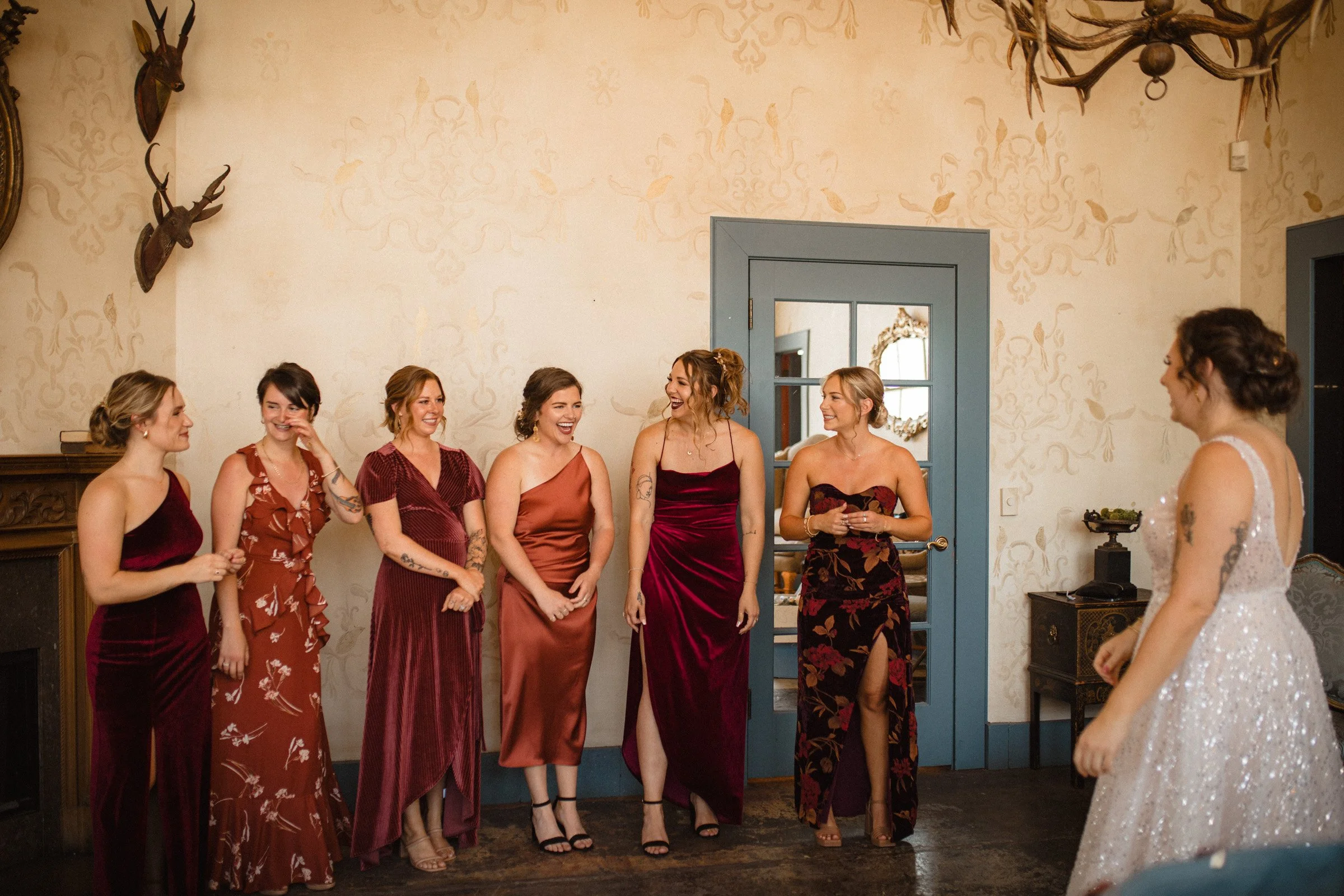 Bridesmaid wait in anticipation for the bride to reveal herself in her dress in the bridal suit. The Ruins Queen Anne, Seattle