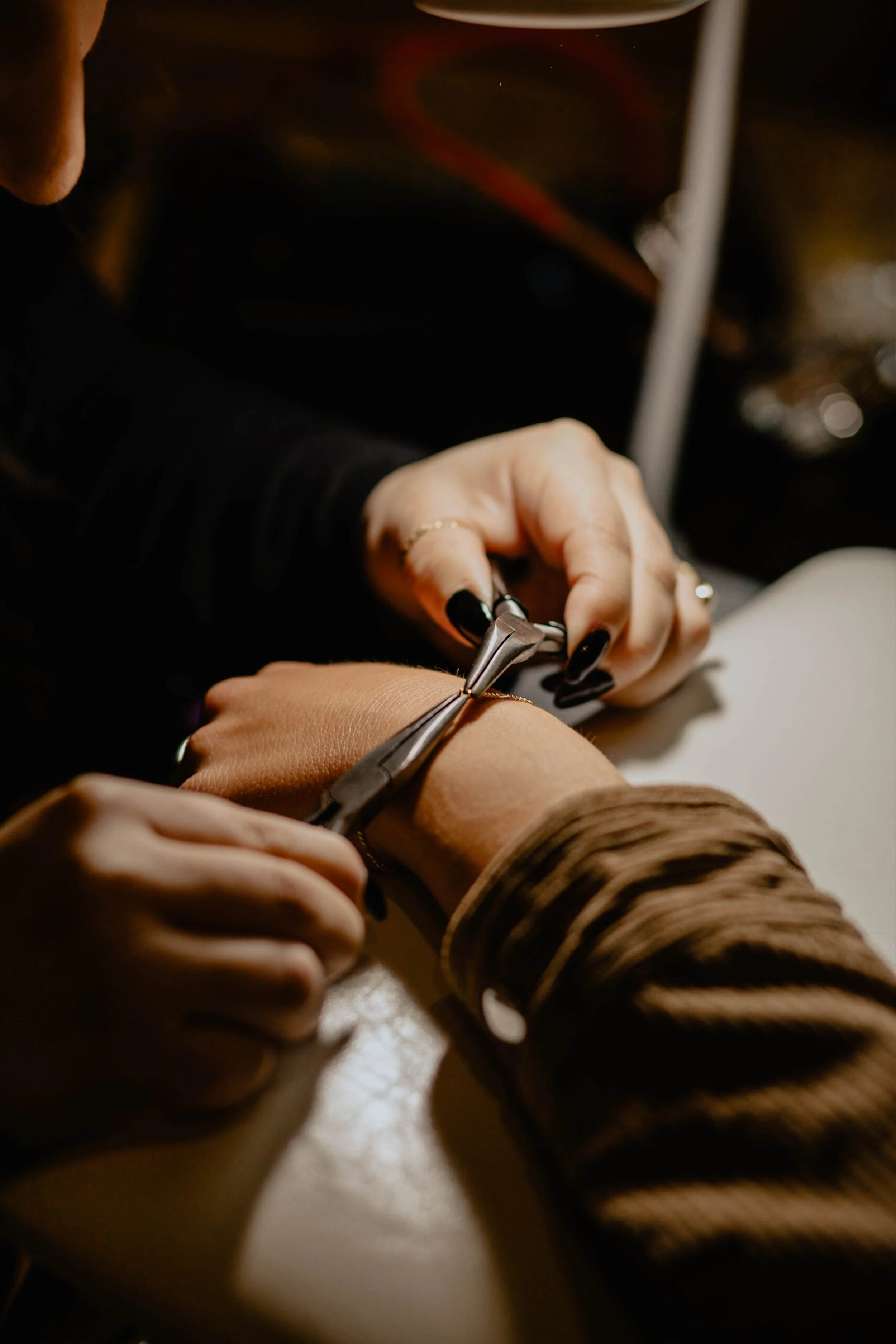 A person receiving a manicure from a nail technician using nail clippers. Seattle professional head shot photography