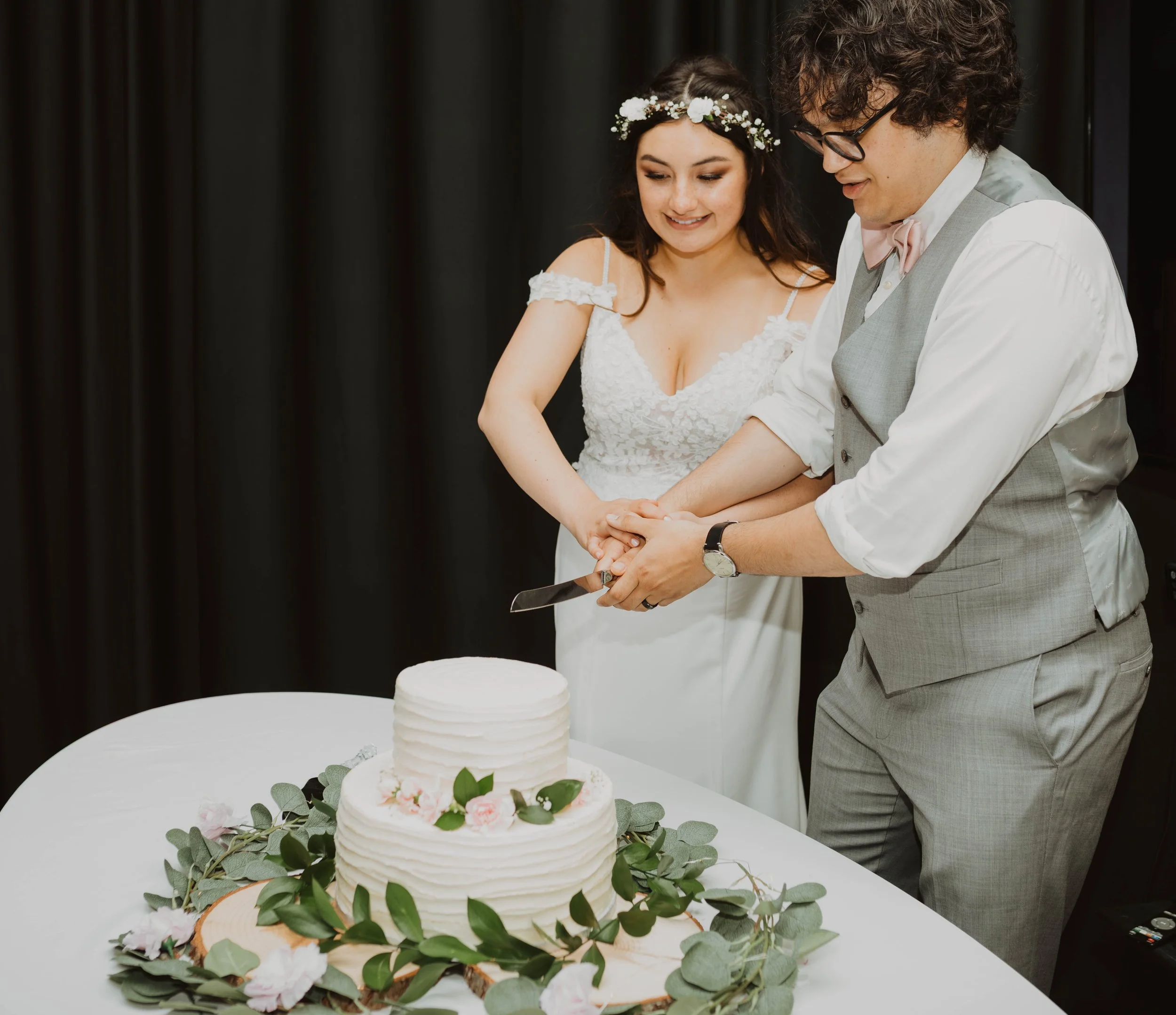 A bride and groom cutting a wedding cake together at their wedding reception. Seattle, WA wedding photography.