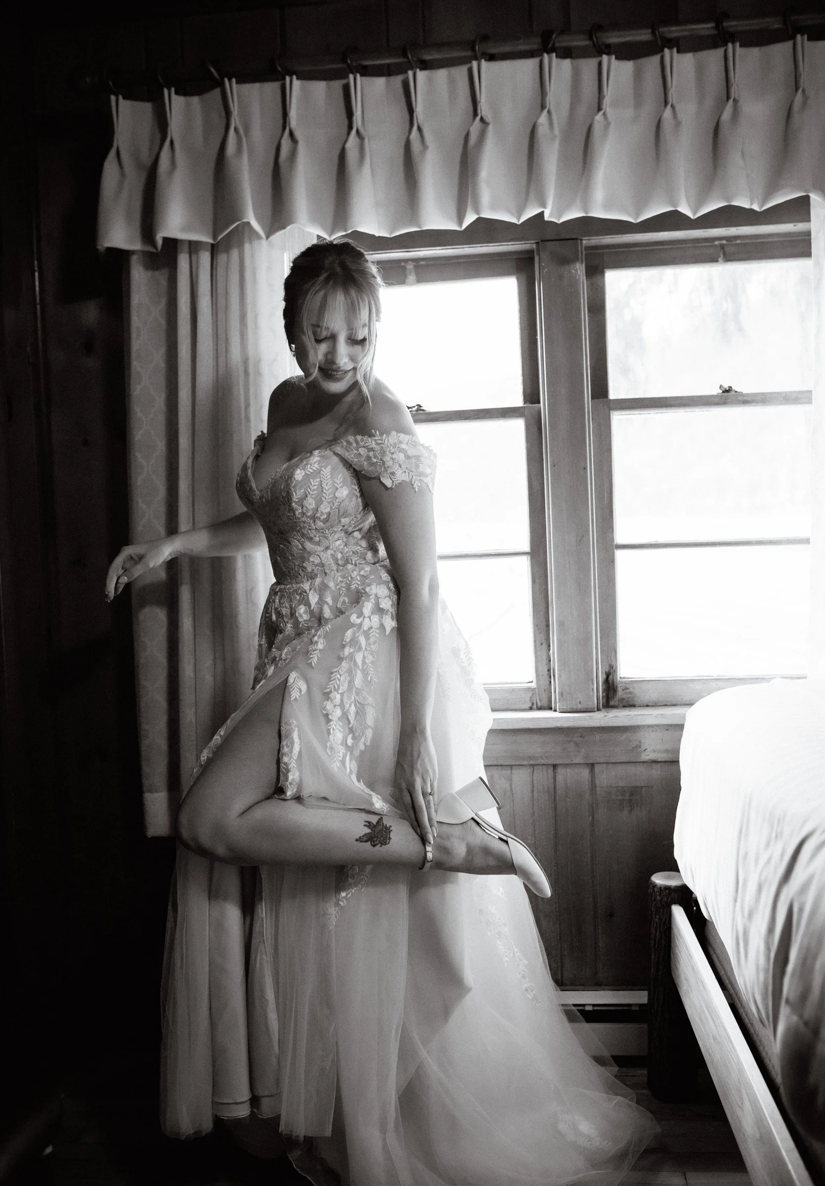 Candid moment of the bride putting on her shoes before her Lake Crescent Lodge ceremony in Port Angeles, Washington.