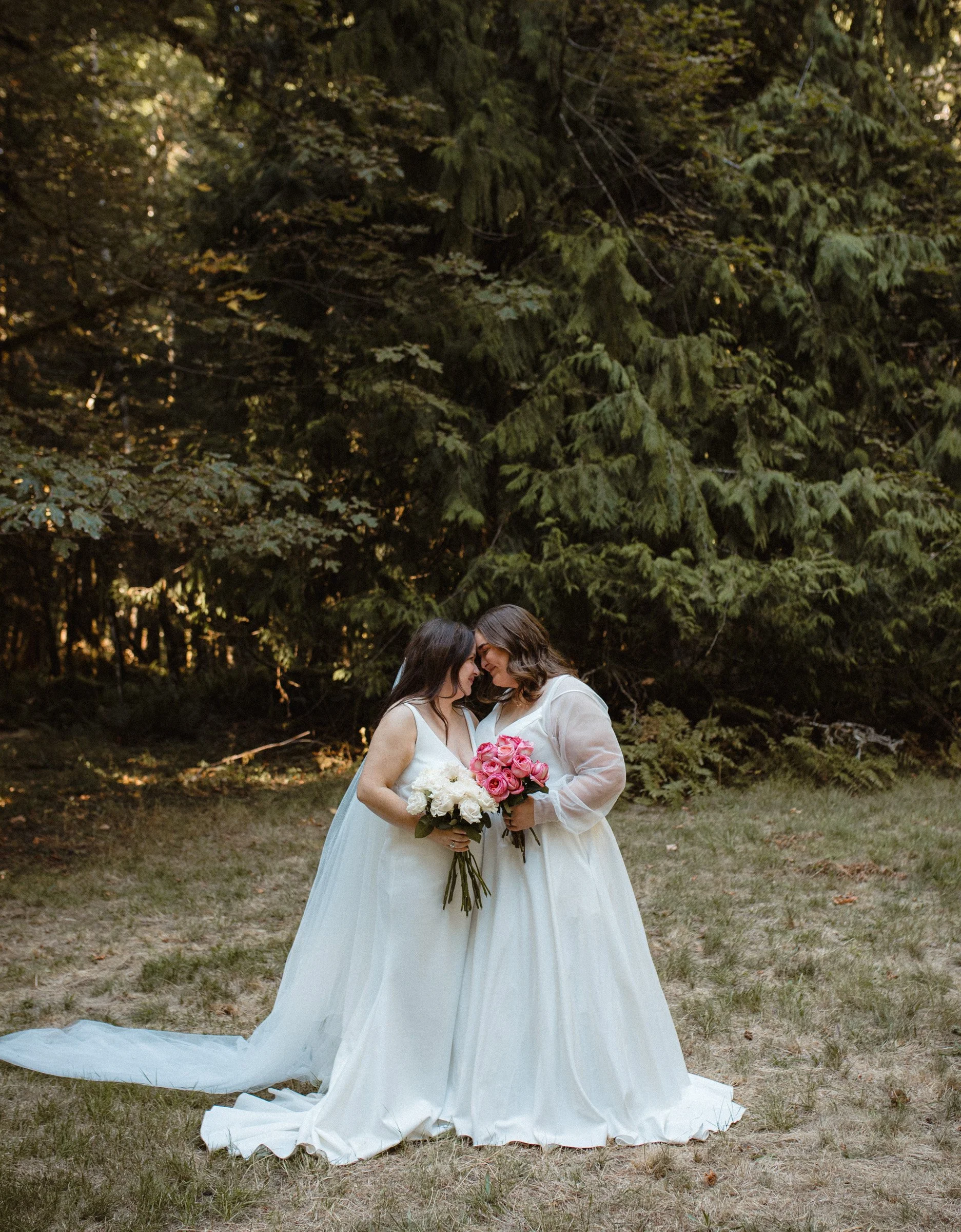 Two brides posing together during wedding portraits in Port Angeles, Washington