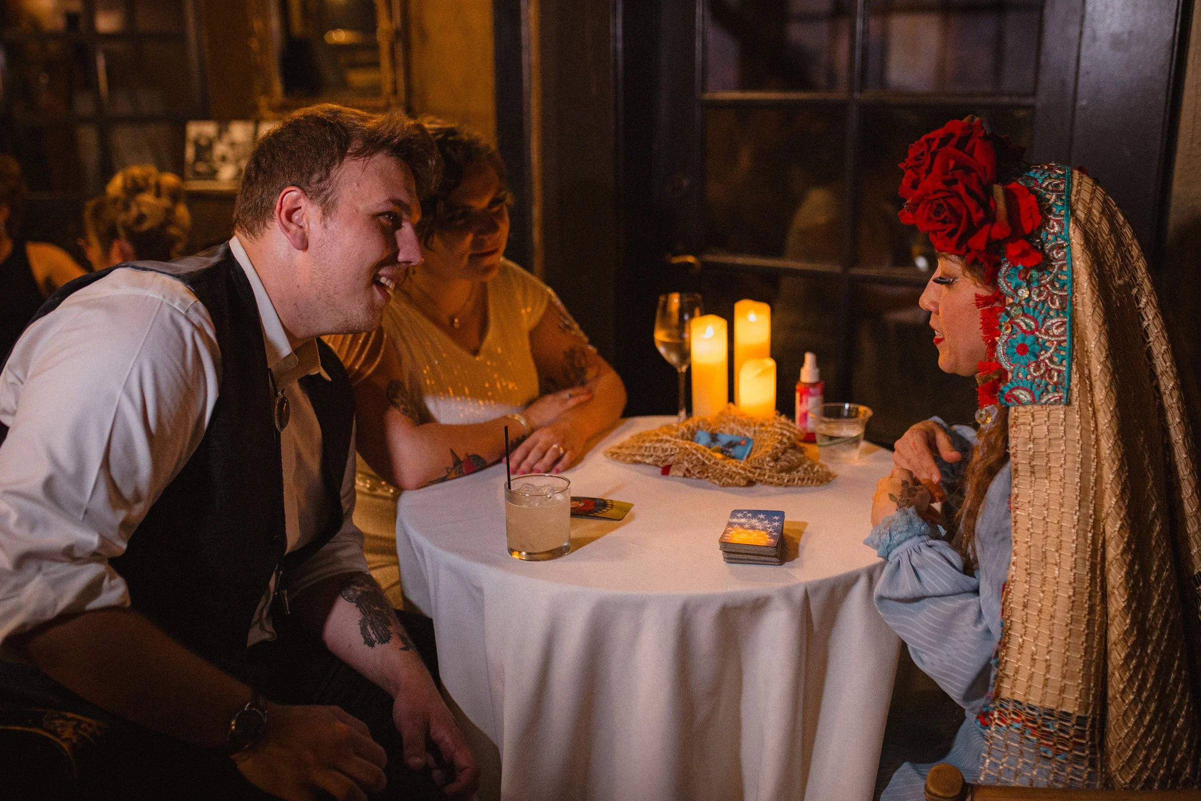 Bride and groom get a tarot card reading done during their wedding recpetion at The Ruins in Queen Anne, Seattle