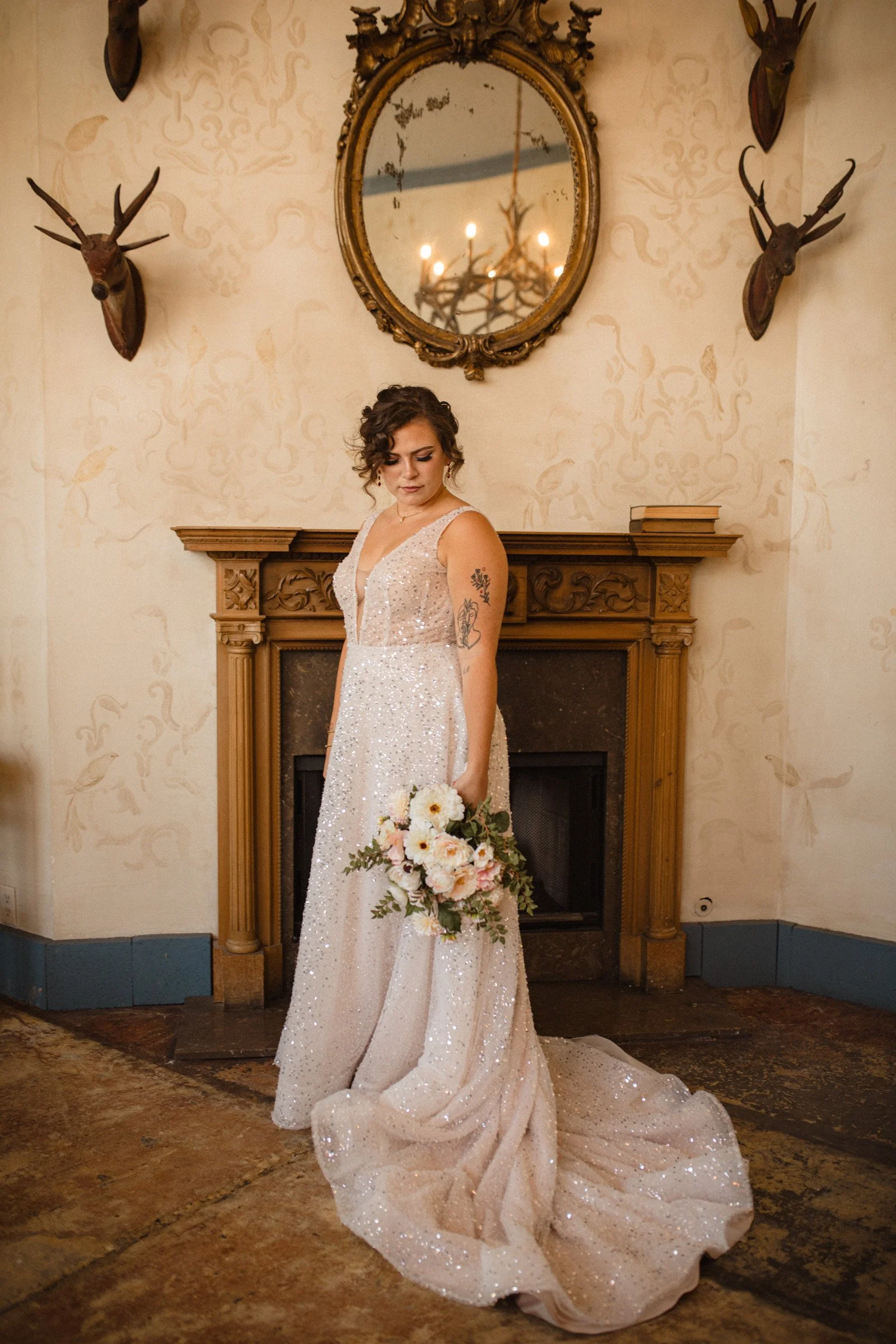 Bride stands in her shimmering wedding dress in the bridal suite of The Ruins, Queen Anne Seattle