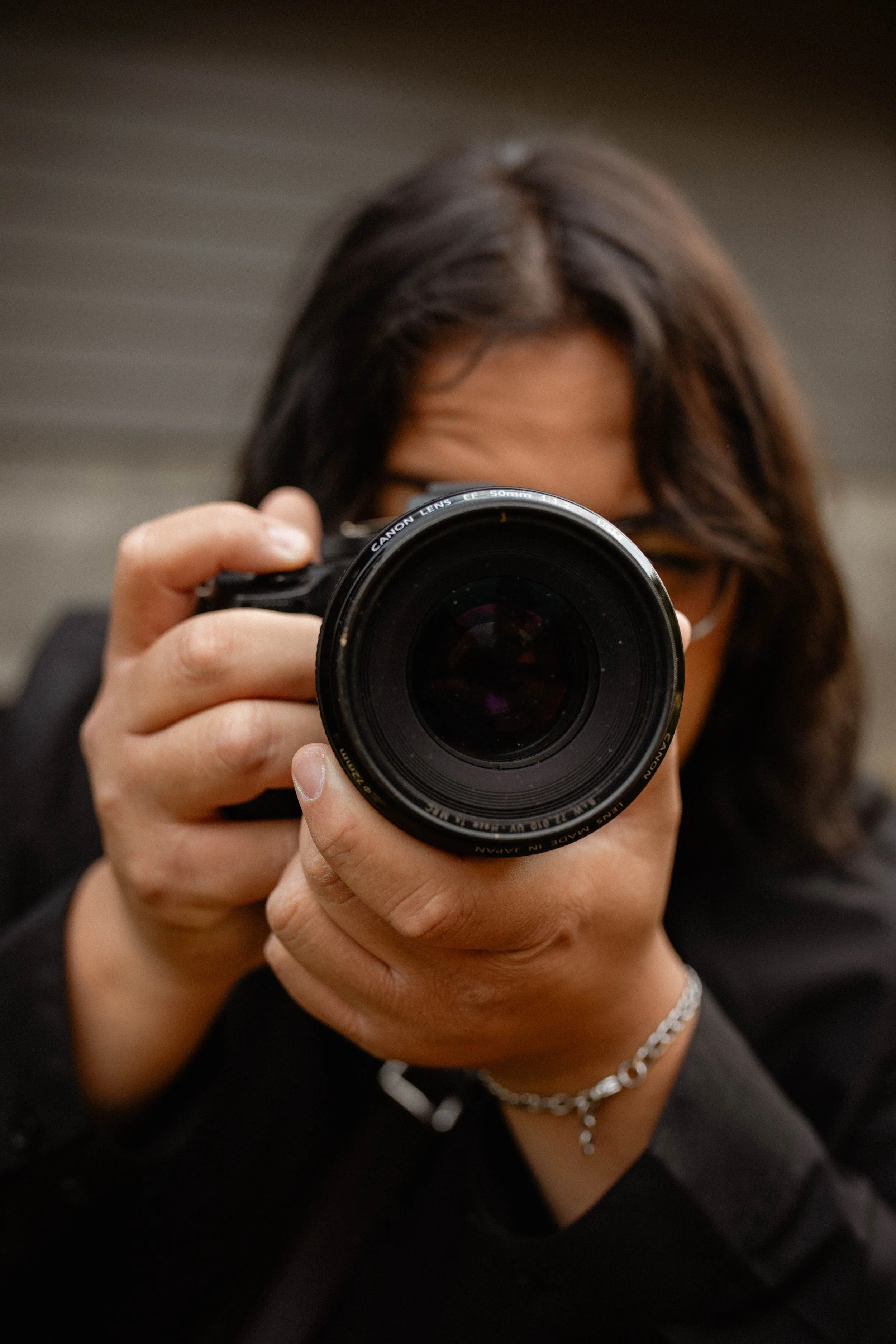 Person taking a photo with a professional camera in an indoor setting. Seattle professional head shot photography