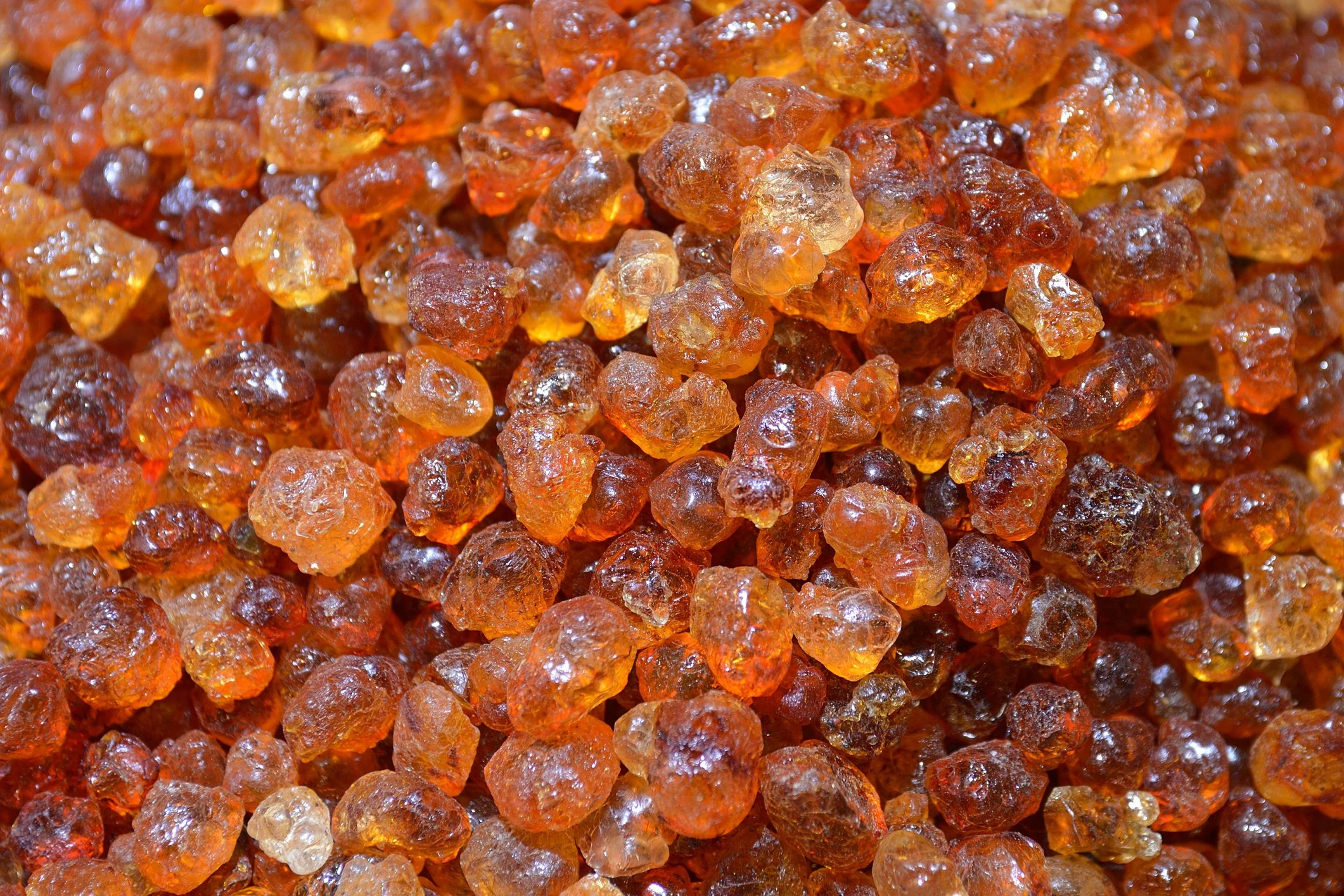 Close-up of raw amber-colored resin or arabic gum.