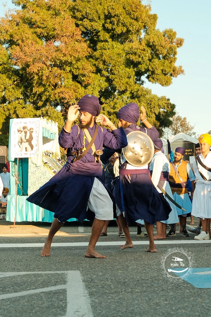 Sikhs performing traditional sword and shield dance during a cultural festival.