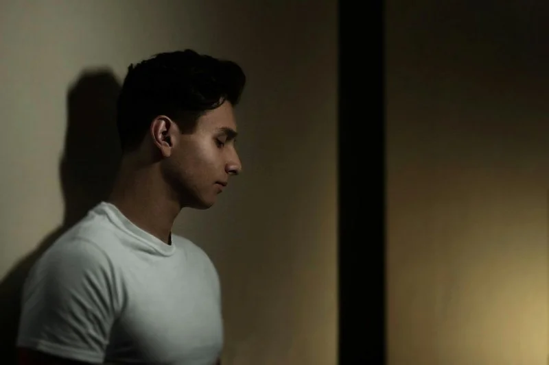 a sad man looking down