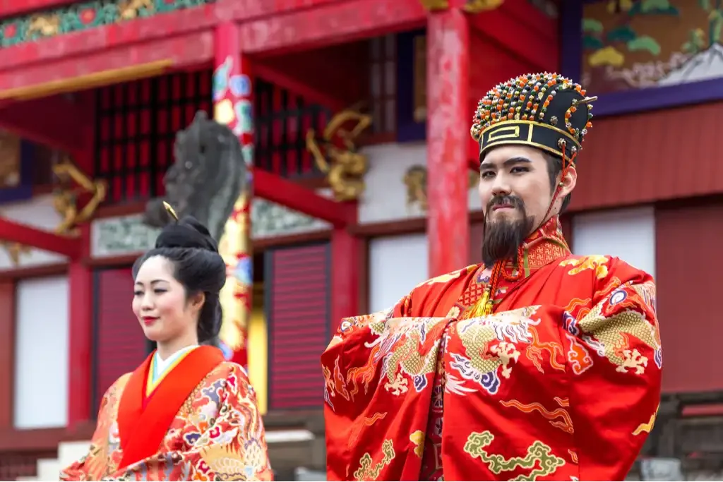 Traditional Okinawan man and woman outside Shuri Castle