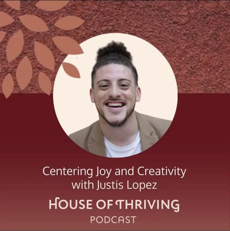 Grayscale photo of a smiling man with dark curly hair tied back, wearing a beige blazer and white shirt, against a white background. The image is part of a graphic design with a red textured background and decorative brown leaves in the upper left corner, promoting the 'House of Thriving' podcast with Justis Lopez, focusing on joy and creativity.