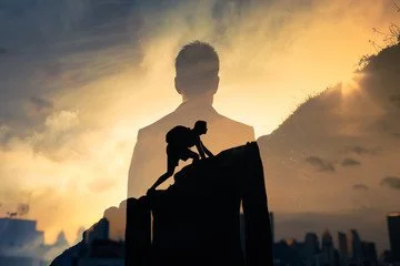 Silhouette of a person crouching on a fence at sunset with a large transparent human figure in the background.