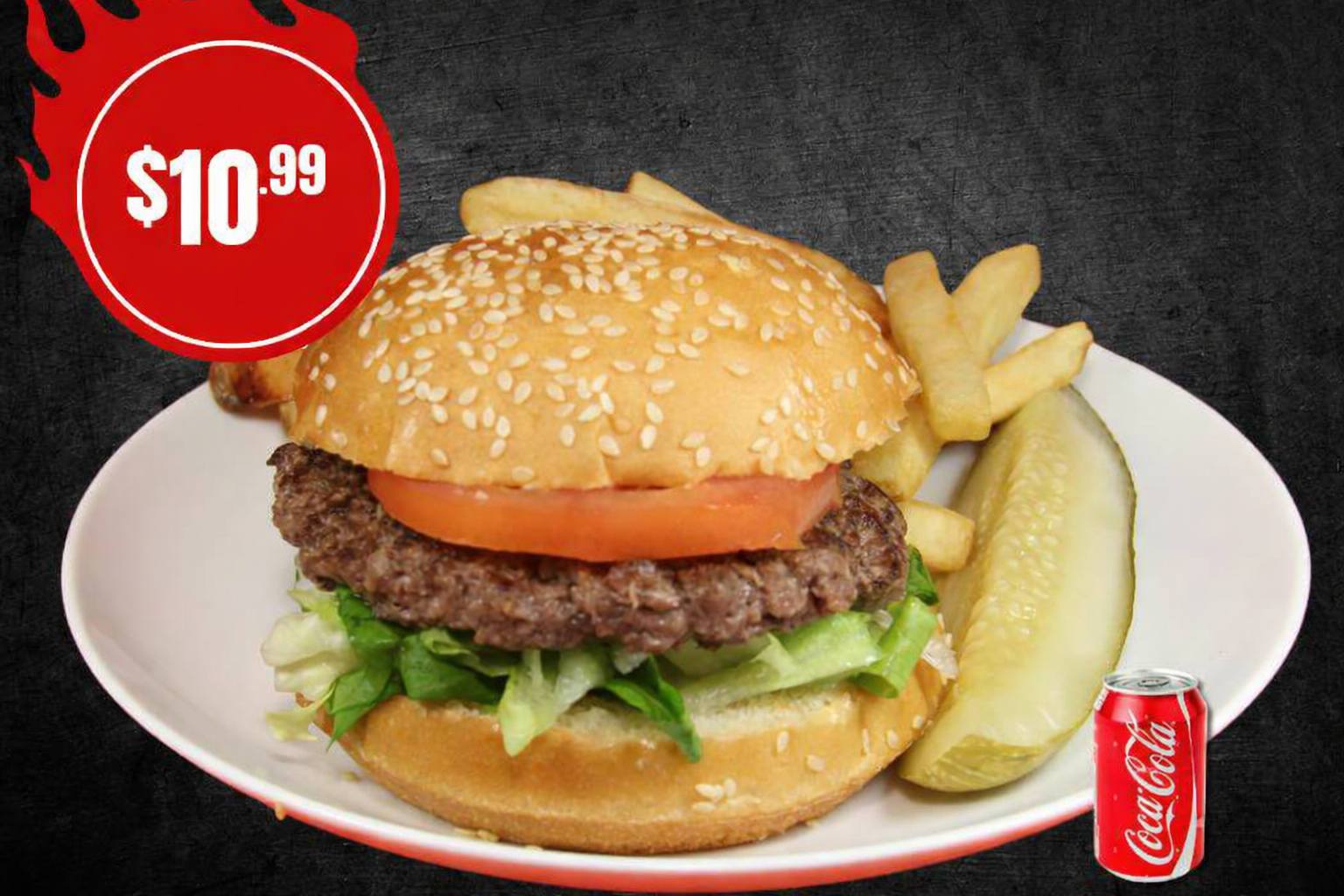 Burger with fries, a pickle, and a drink
