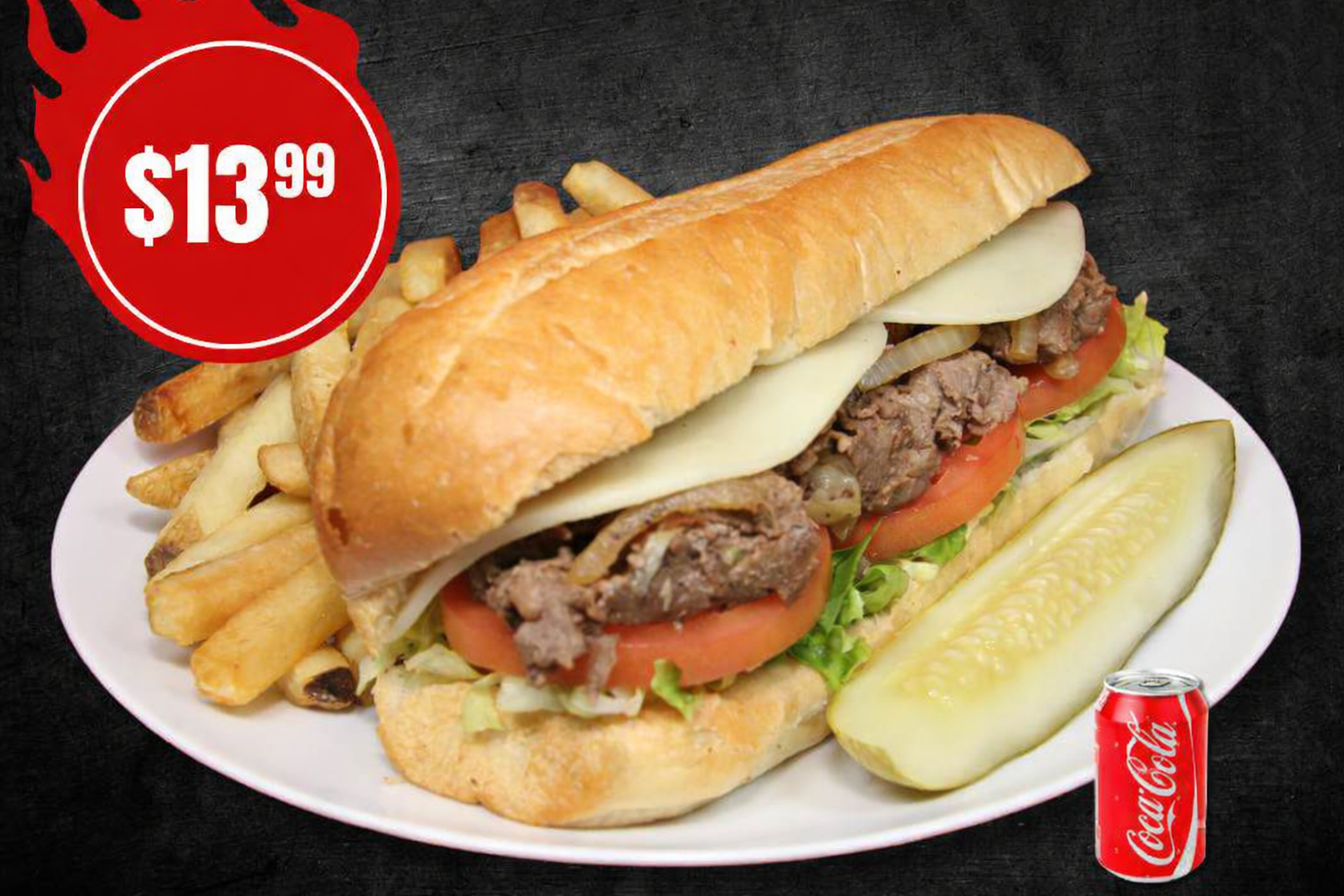 Steak and cheese sub with fries, a pickle, and a drink