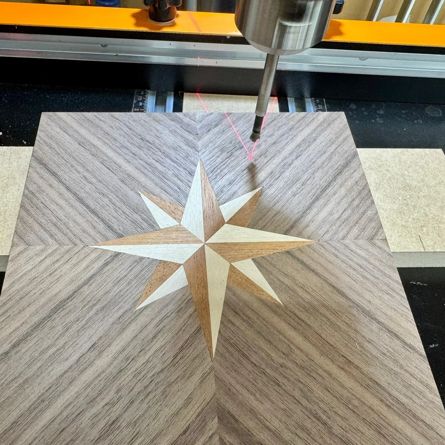 Drilling a bunch of holes in the completed compass rose to allow for all the brass infill &quot;stars&quot;. One is special.