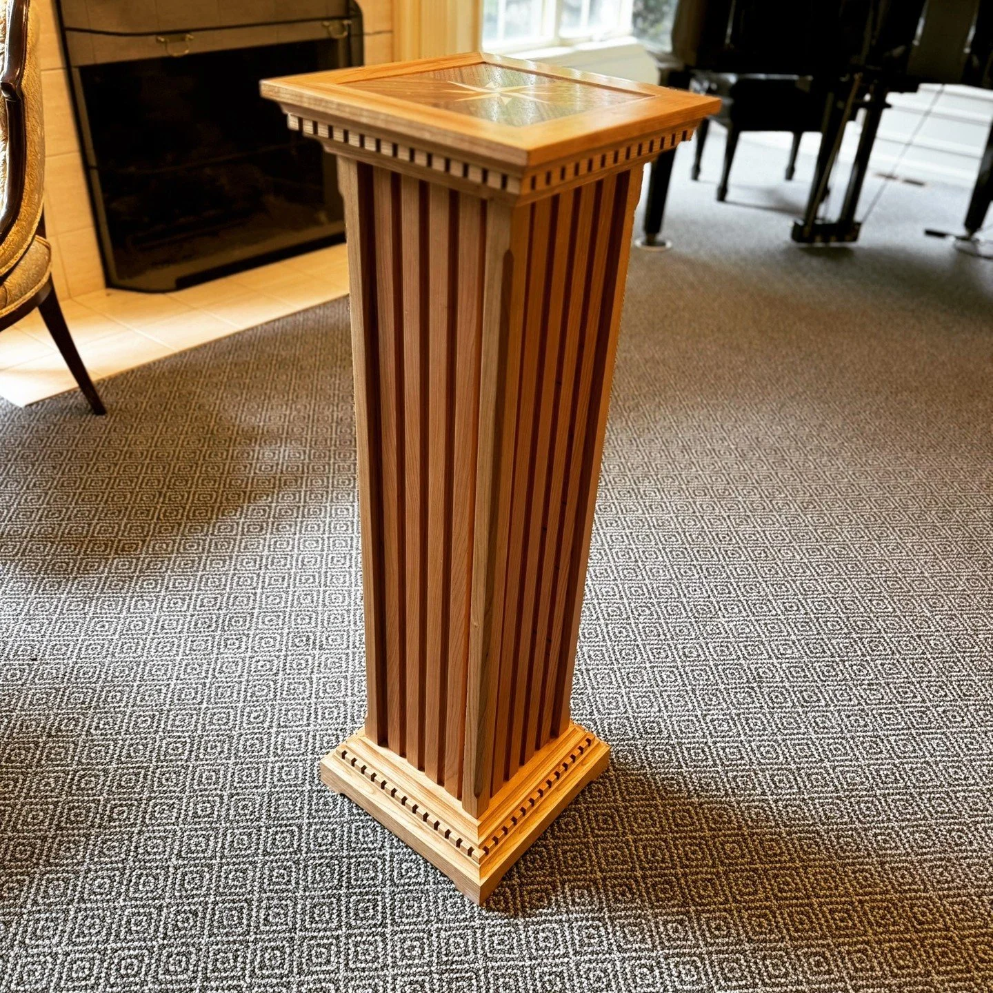 The Puzzle Pillar. Besides being a great piece to display puzzle boxes, it also is a puzzle unto itself!