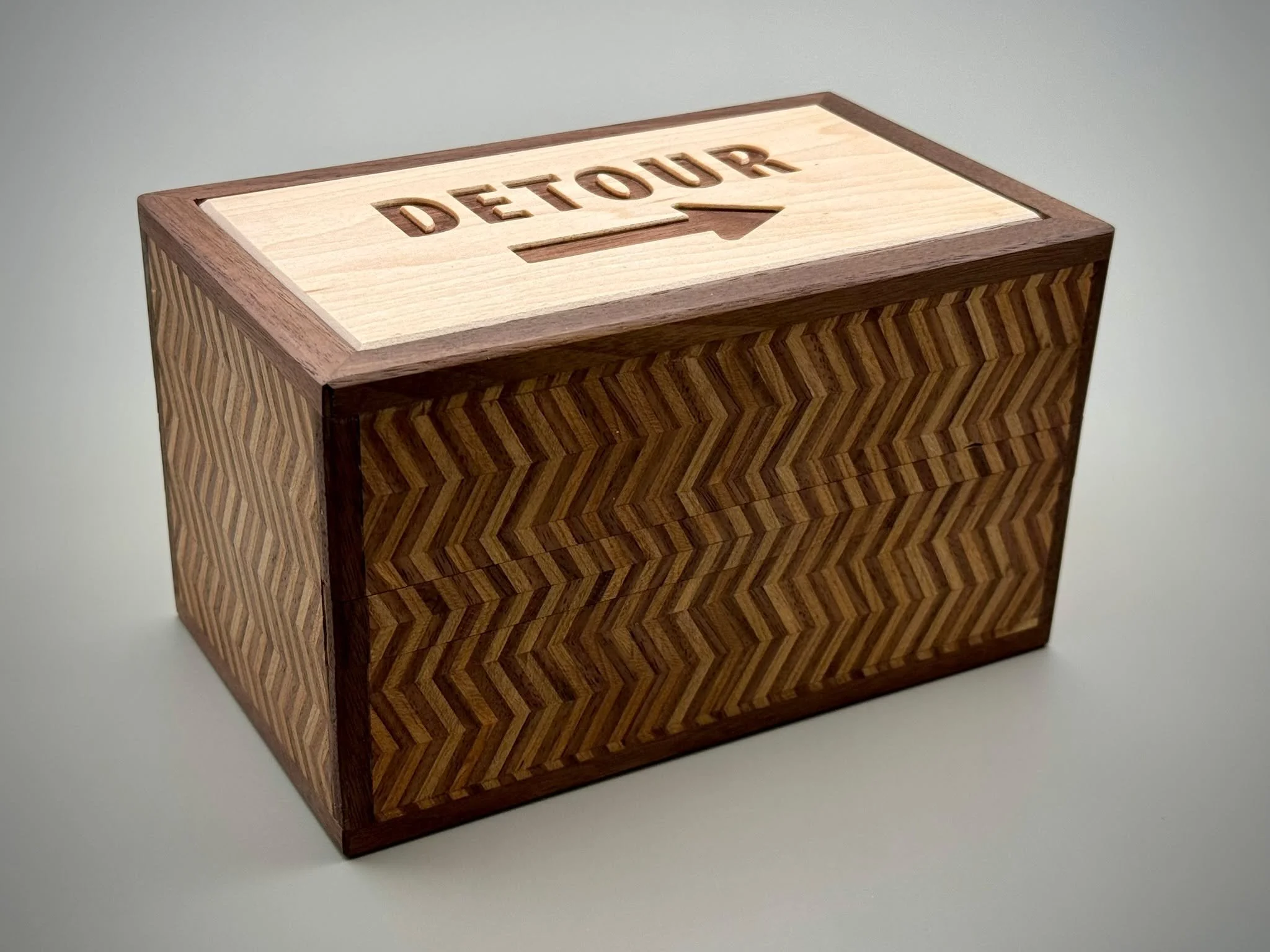 Introducing the Detour Box.

After many months of work, my latest puzzle box design is ready to share. This prototype features Nokozuku-cut cherry and walnut yosegi veneer that I planed by hand. For the production run, I&rsquo;ll be switching to Hiki