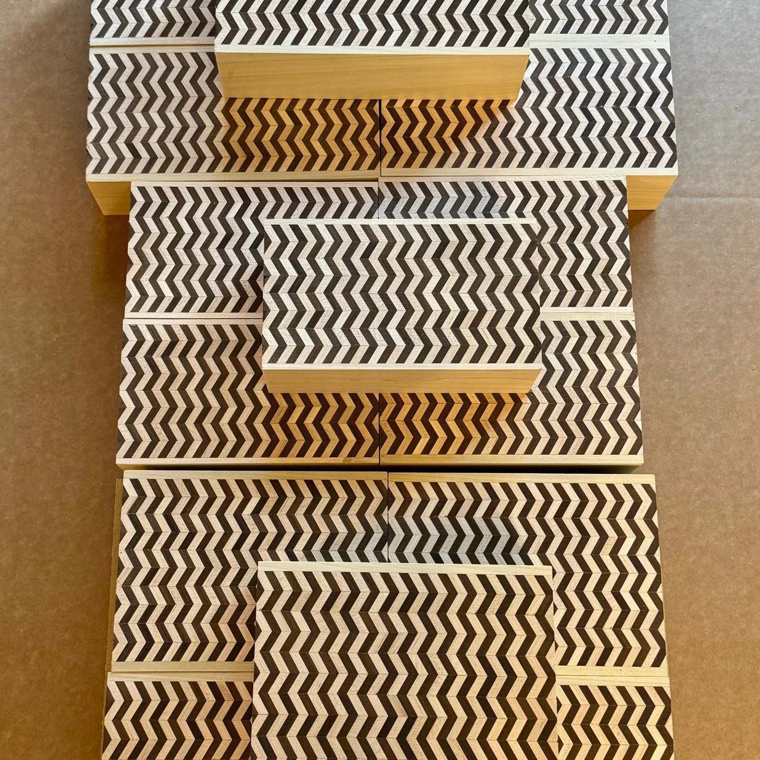 The tanegi blocks (the patterned billets from which veneers are sliced) for the Detour box are now complete.

Each tanegi passes through a number of stages: straight out of the clamping jig, drum-sanded flat, and trimmed square, before being assemble