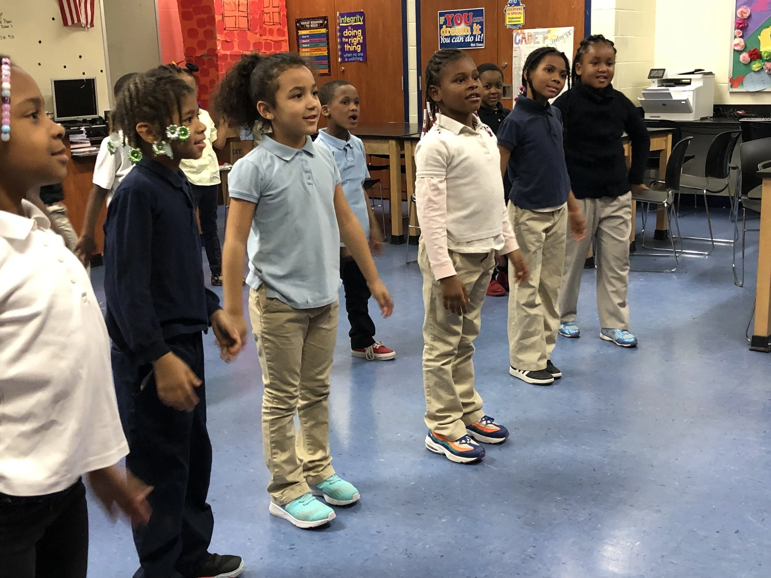 Children standing up ready for activity in classroom