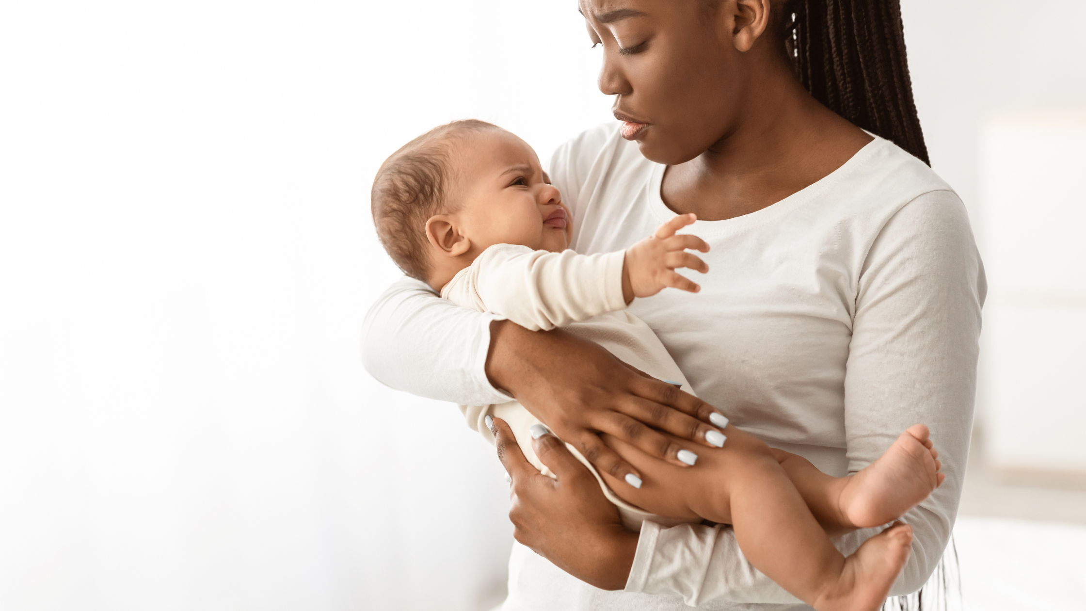 concerned mom holding baby