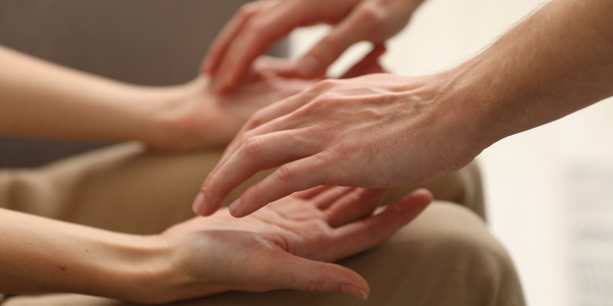 two people's hands hovering over each other