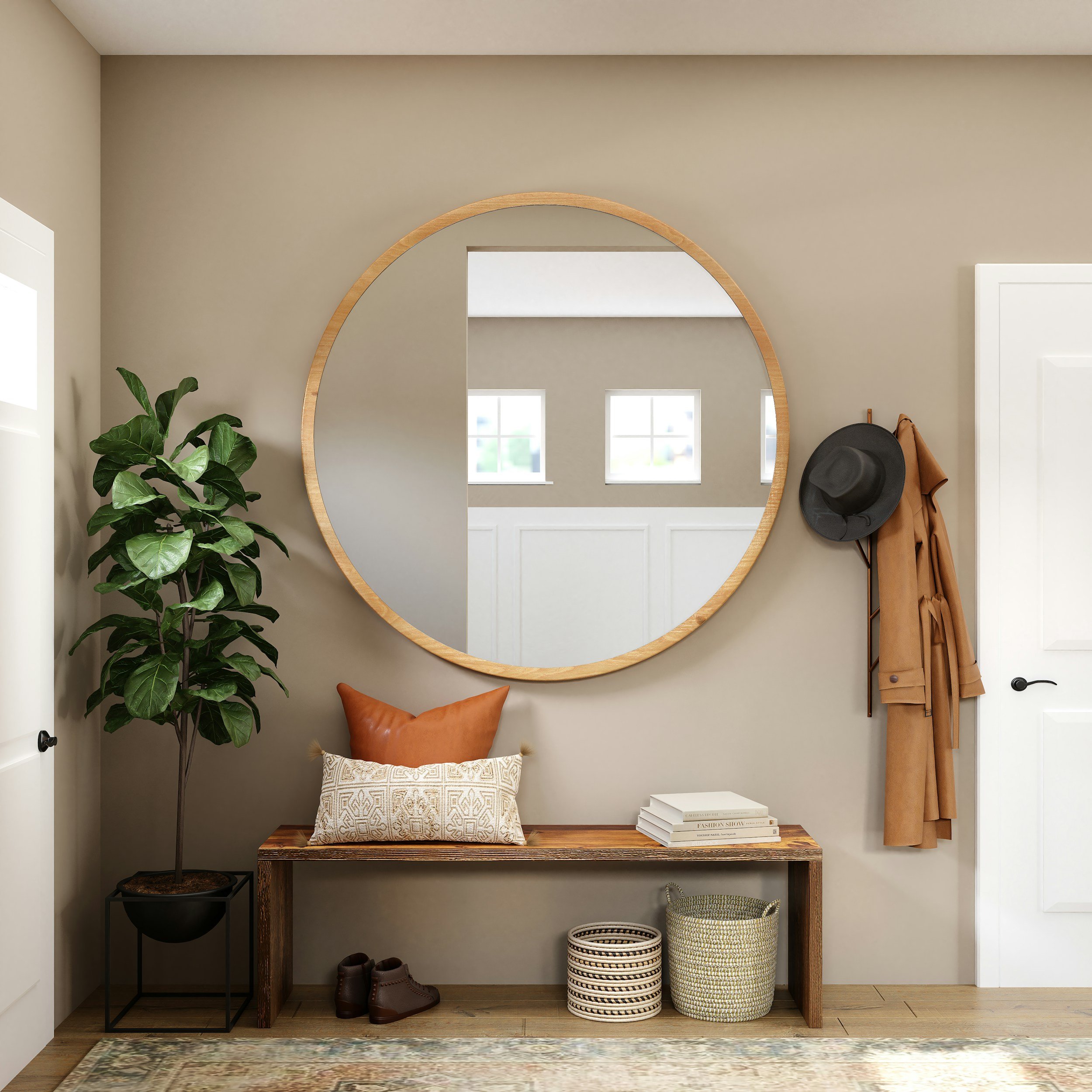 Entryway with a large round mirror, a potted plant, a small table with a cushion, stacked books, woven baskets, boots, a hat, and a coat hook on a beige wall.