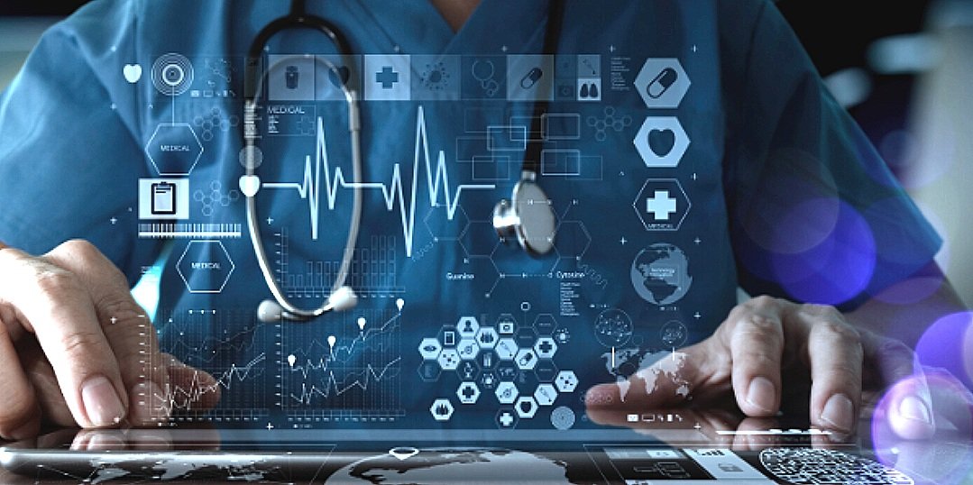 A healthcare professional using a digital tablet with overlaid medical and health data graphics, including heart rate monitors and medical icons.