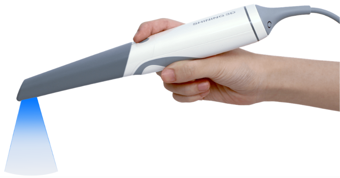Close-up of a hand holding a handheld device emitting a blue light.