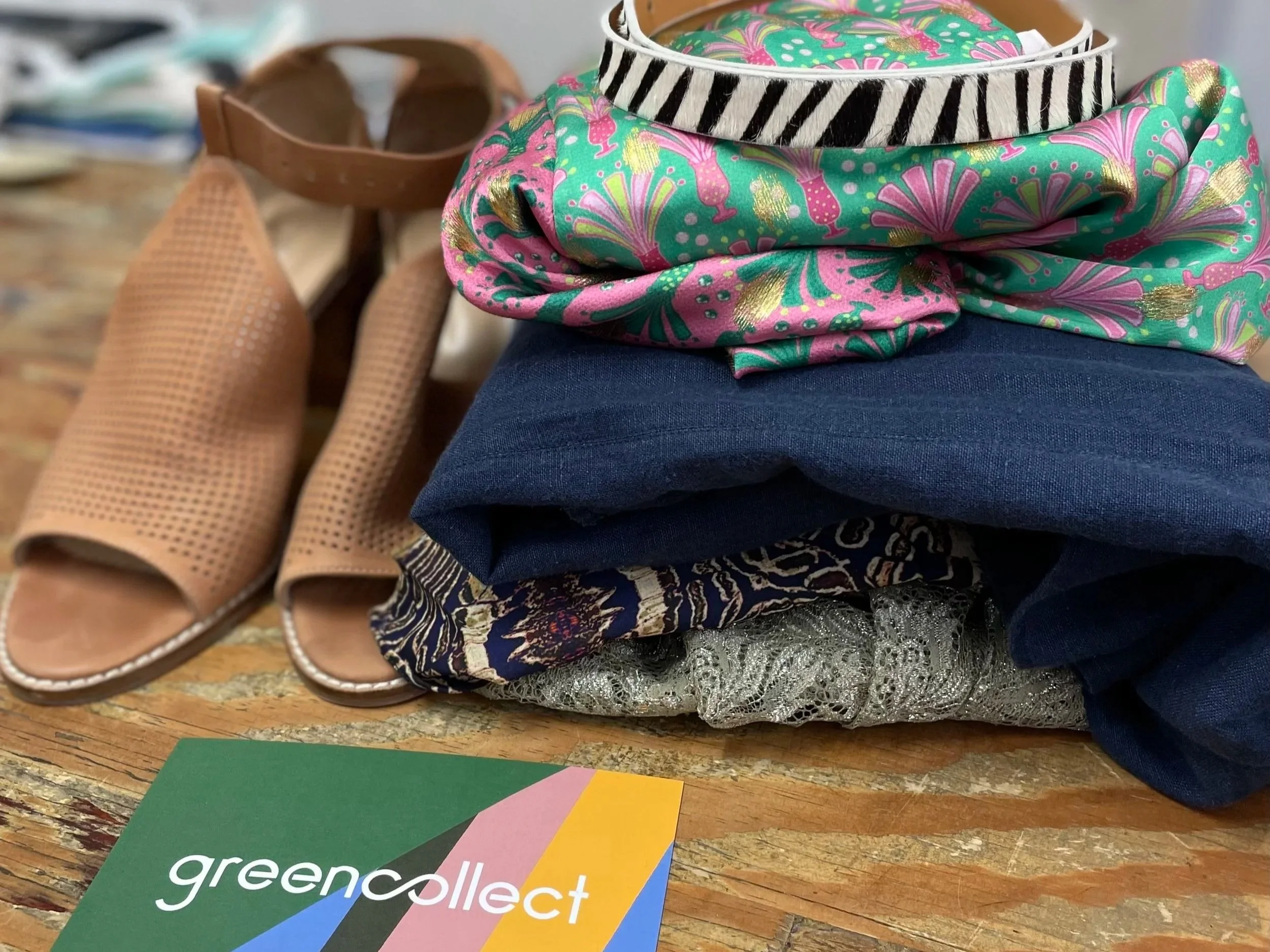 Stack of clothes with shoes and a Green collect card
