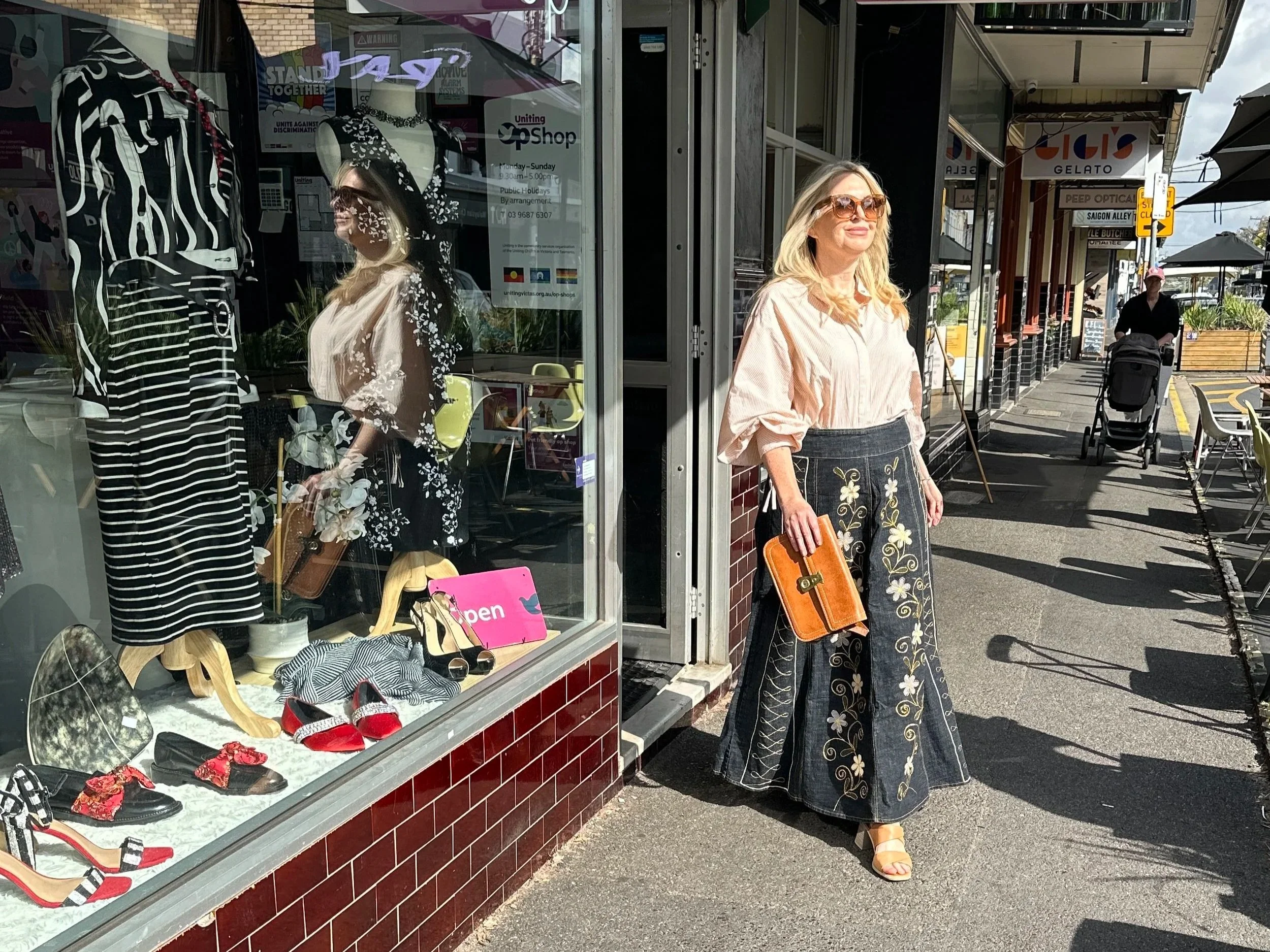 woman walking out of op shop in long maxi skirt