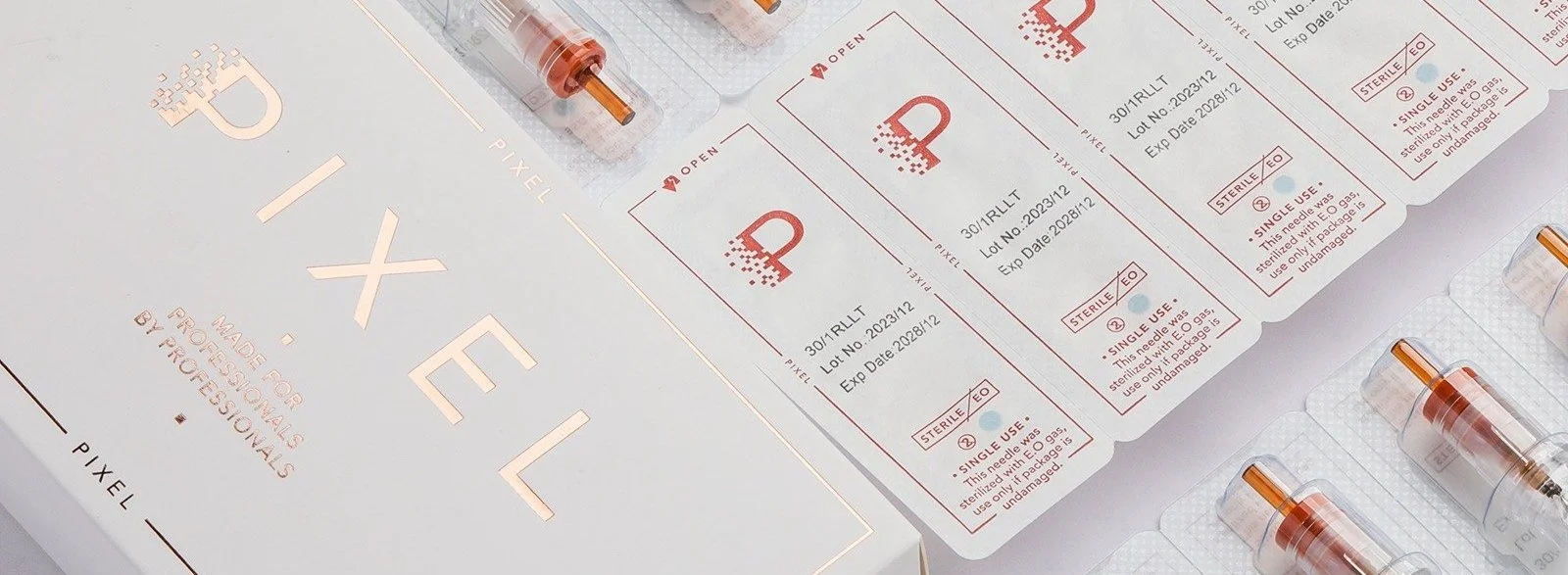 Boxes of syringes or vaccine vials with labels, arranged on a white surface with a pamphlet or packaging for medical supplies.