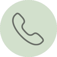 Line drawing of a telephone handset inside a green circle.