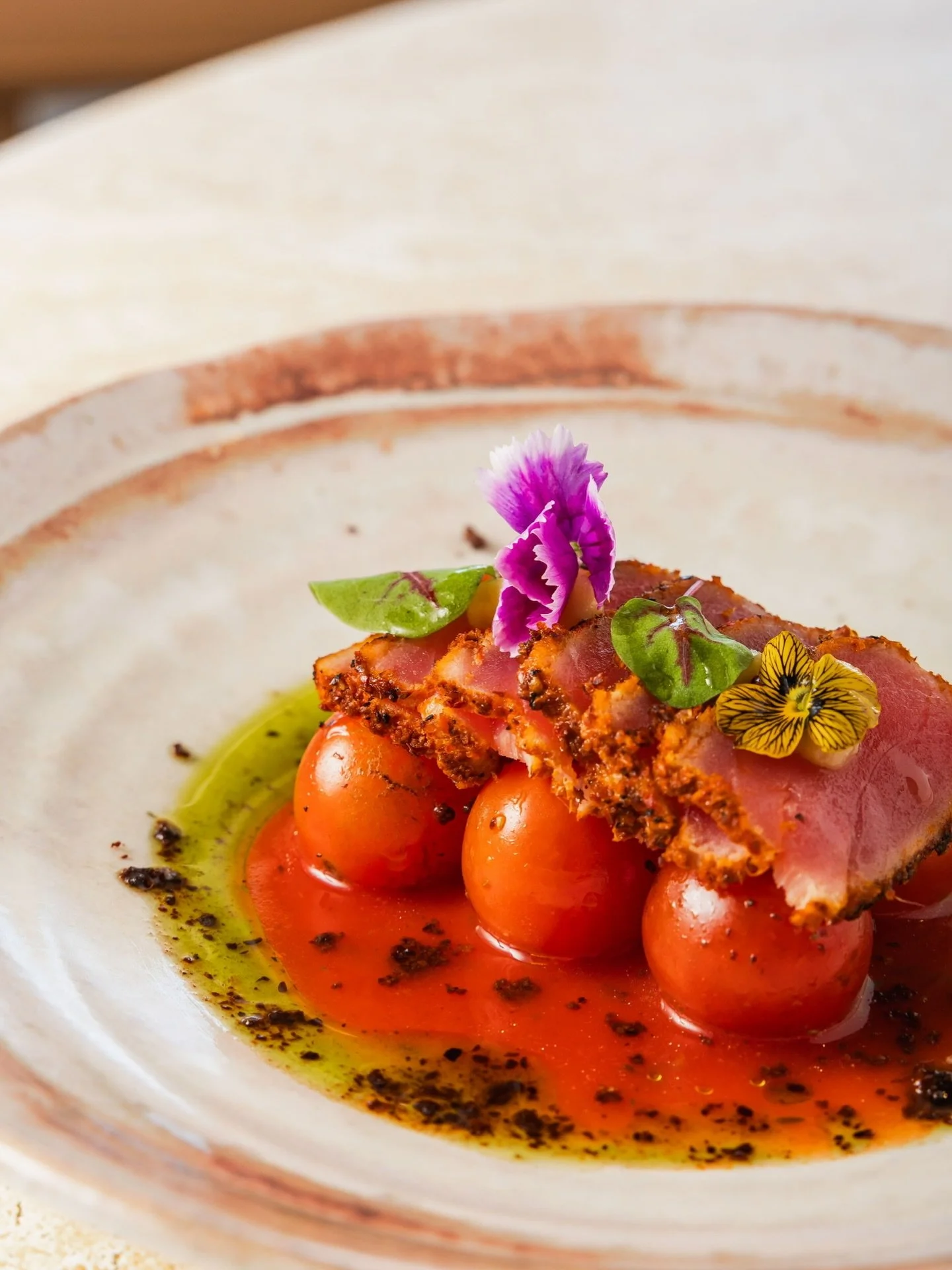 Dive into our delicate Yellowfin Tuna Tataki - thinly sliced, perfectly seared and paired with smoked Bloody Mary tomatoes, confit garlic and olive crumb. A coastal favourite that captures the fresh, Mediterranean-inspired flavours of Dune with every