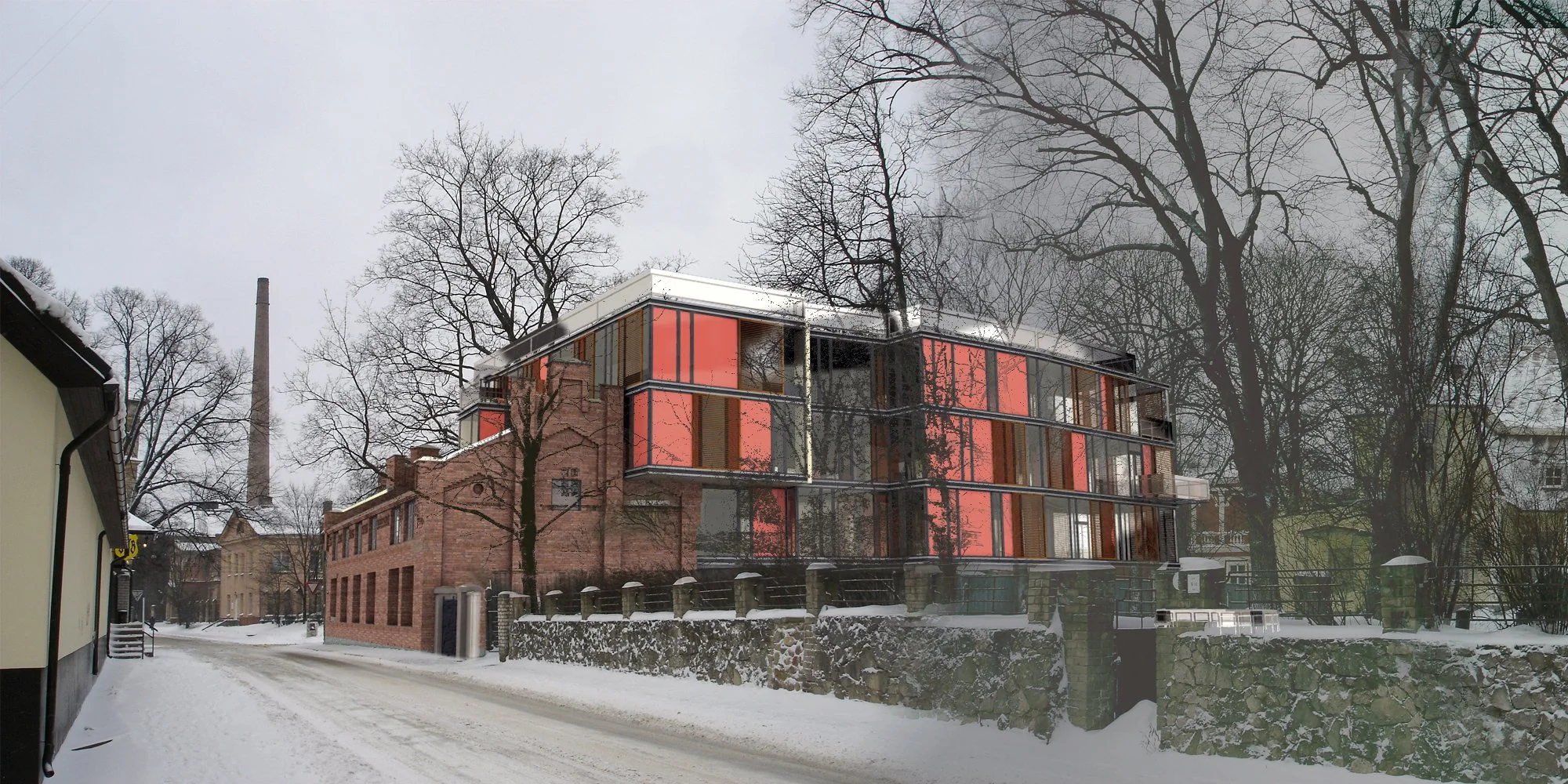 A modern multi-story building with glass walls and red panels, situated on a snow-covered street in winter, surrounded by leafless trees and brick buildings.