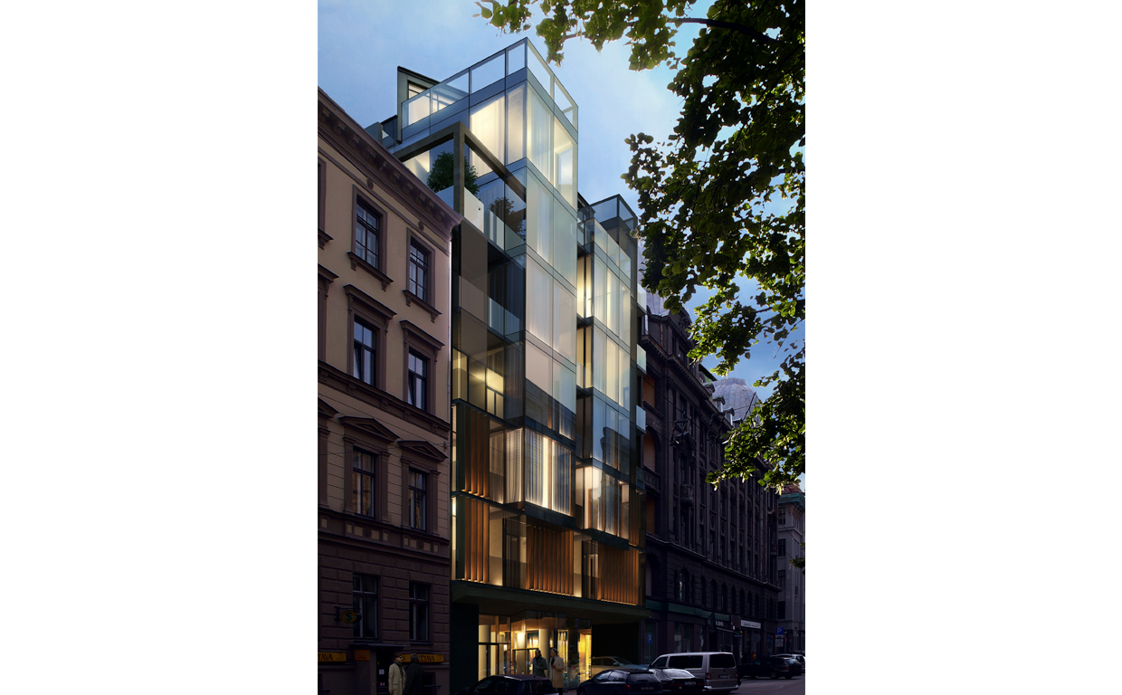 Modern glass residential building on a city street at dusk, with illuminated interiors and neighboring older buildings, and trees in the foreground.