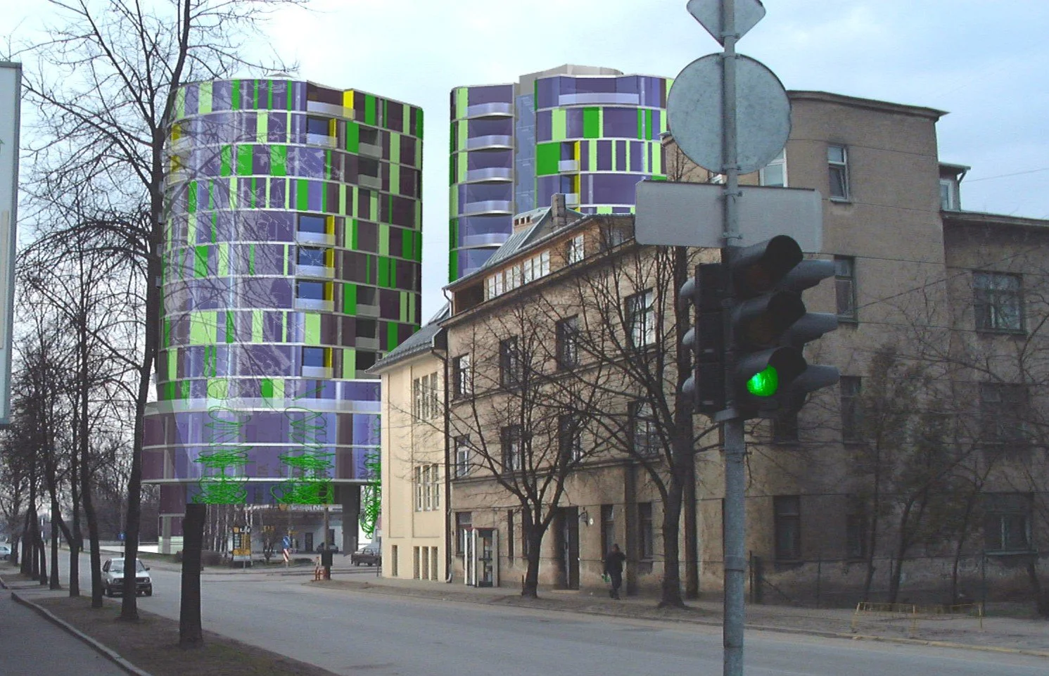 City street scene with a traffic light showing green, old beige buildings and two modern, colorful high-rise buildings with green, purple, and yellow accents in the background.