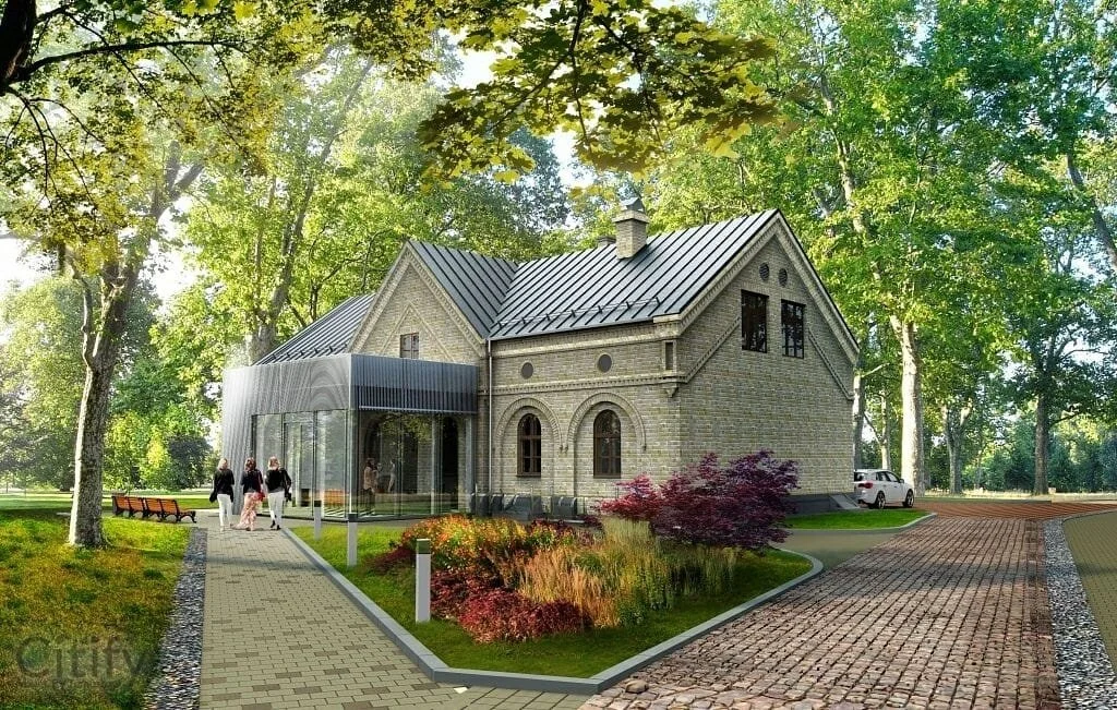 A historic brick house with a modern glass extension, surrounded by tall trees and a landscaped garden, with a paved walkway and parked car in the background.