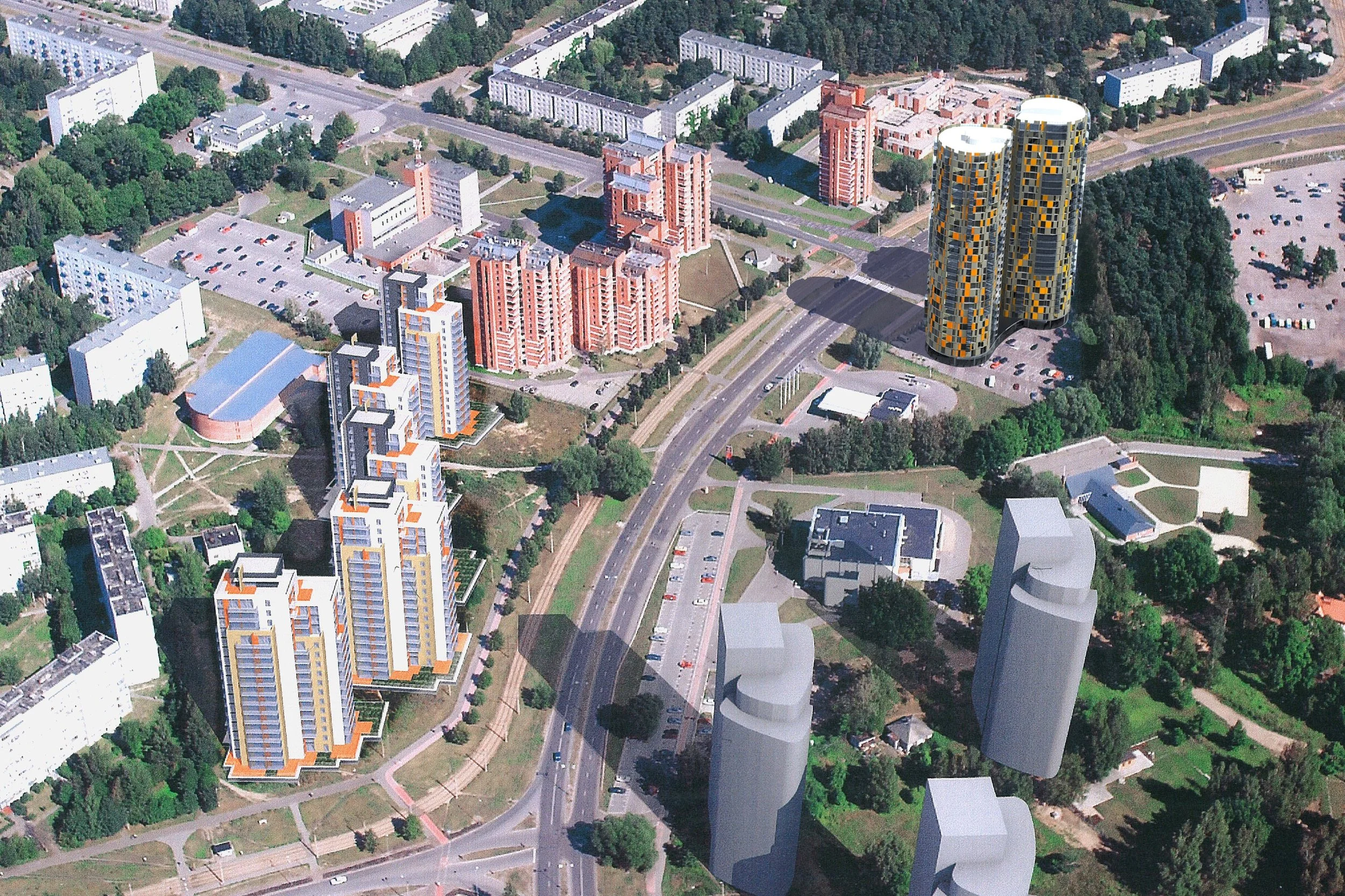 Aerial view of an urban area with several residential apartment buildings, modern twisted towers, green spaces, and parking lots.