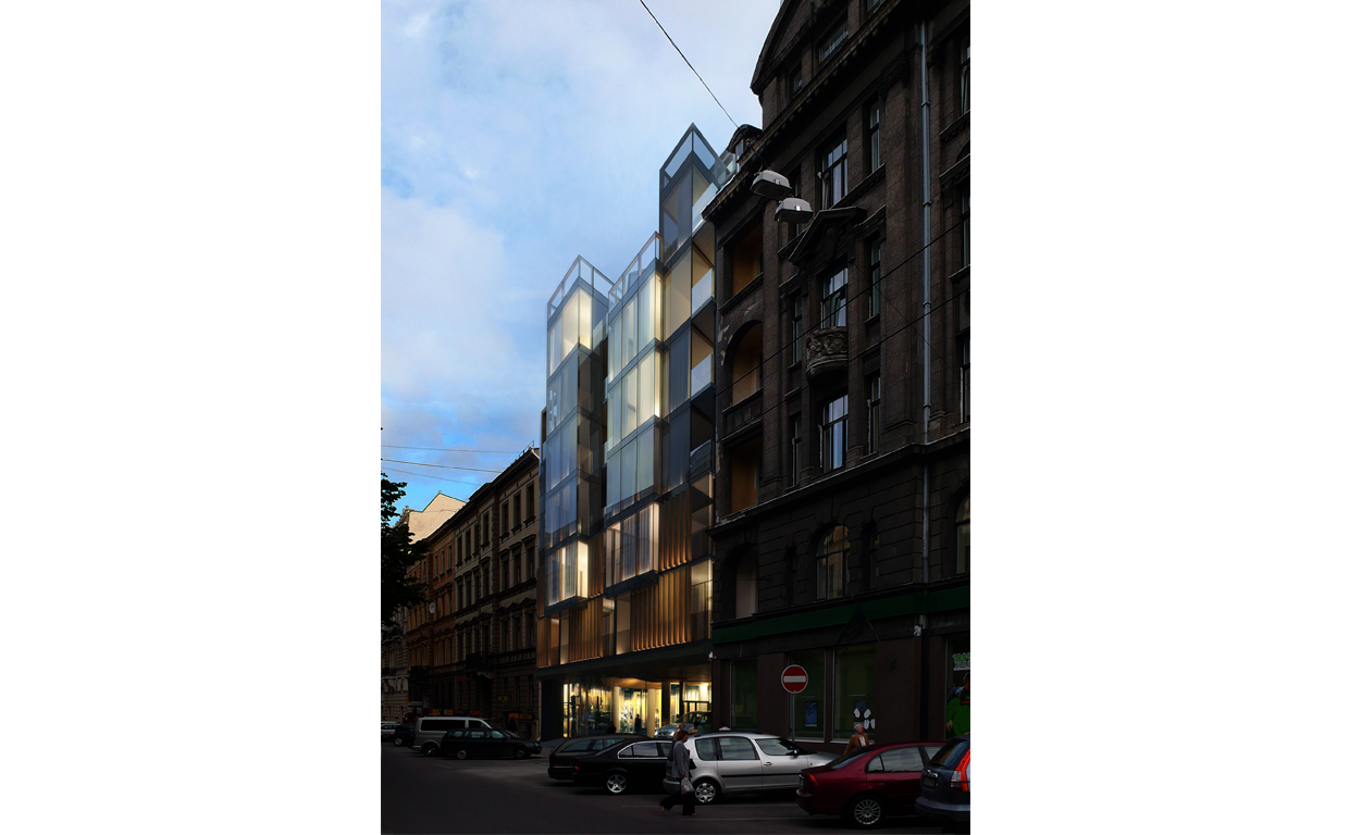 Modern glass and metal building with illuminated windows in an urban street with parked cars and pedestrians, contrasted with classical brick buildings.