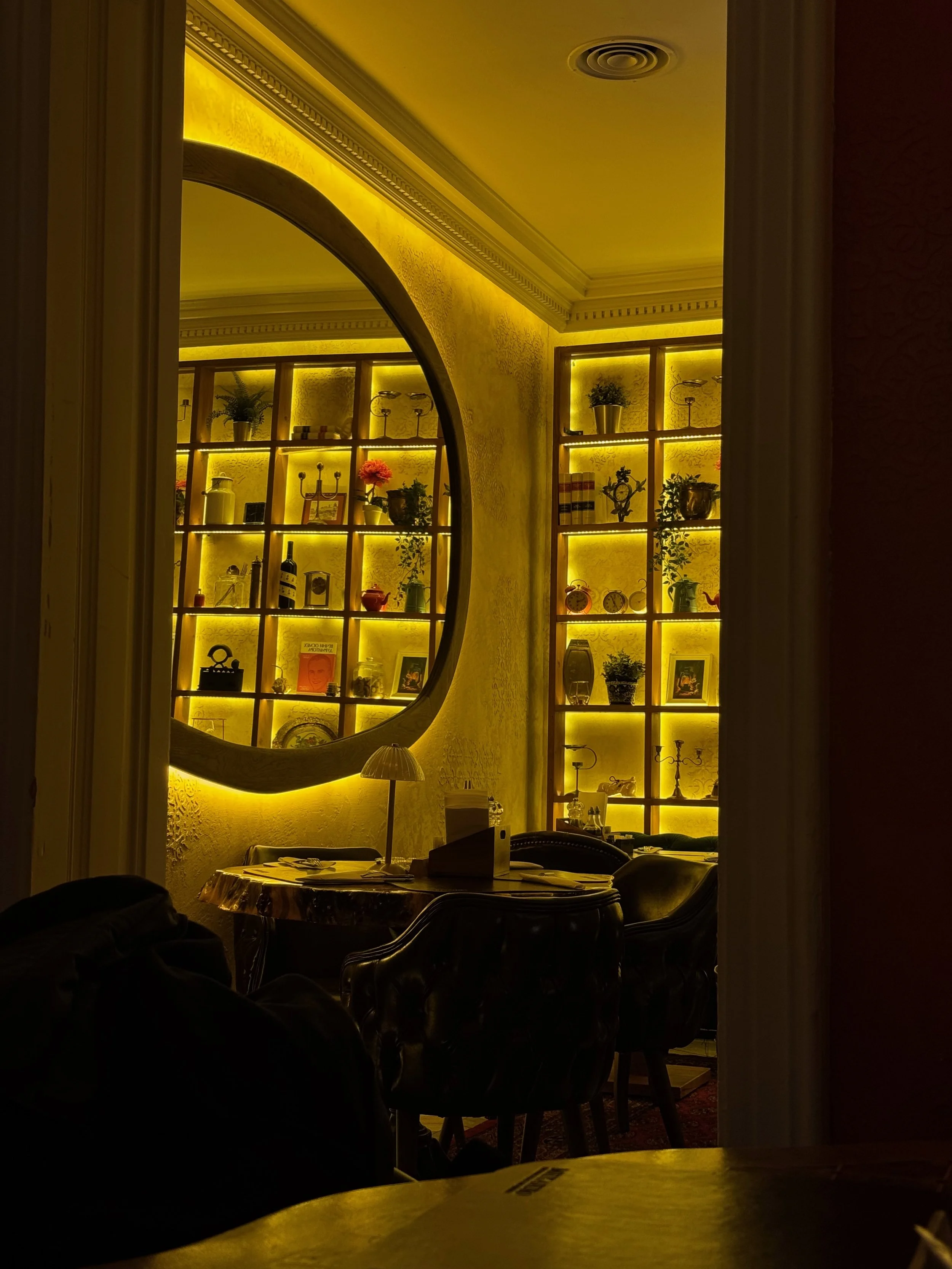 Warmly lit restaurant interior with decorative styling, plants and ambient design details, captured for hospitality branding and social media marketing content.