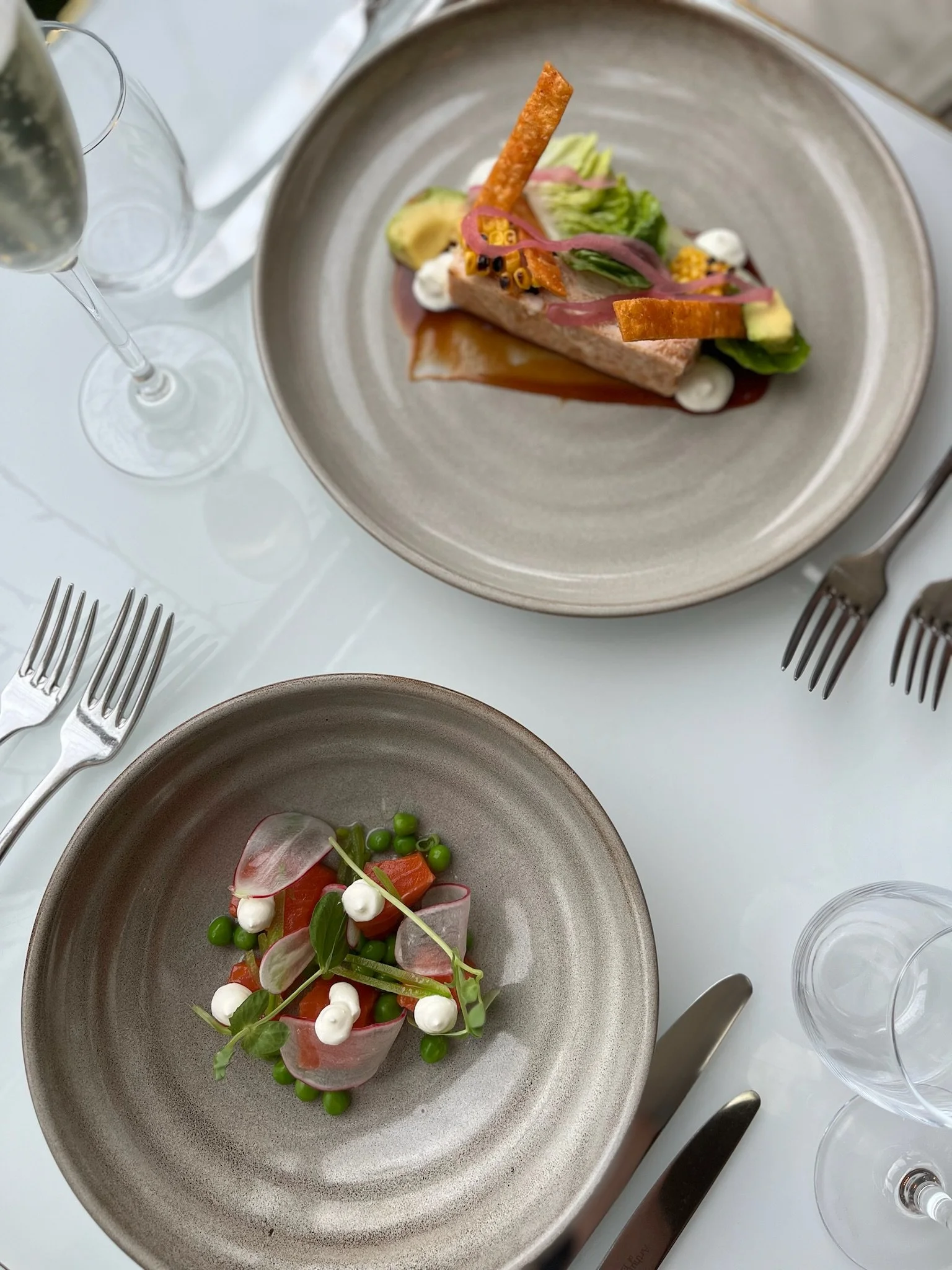 Luxury cocktail and dining table featuring vibrant drinks and plated dishes, created for restaurant and bar social media content creation.