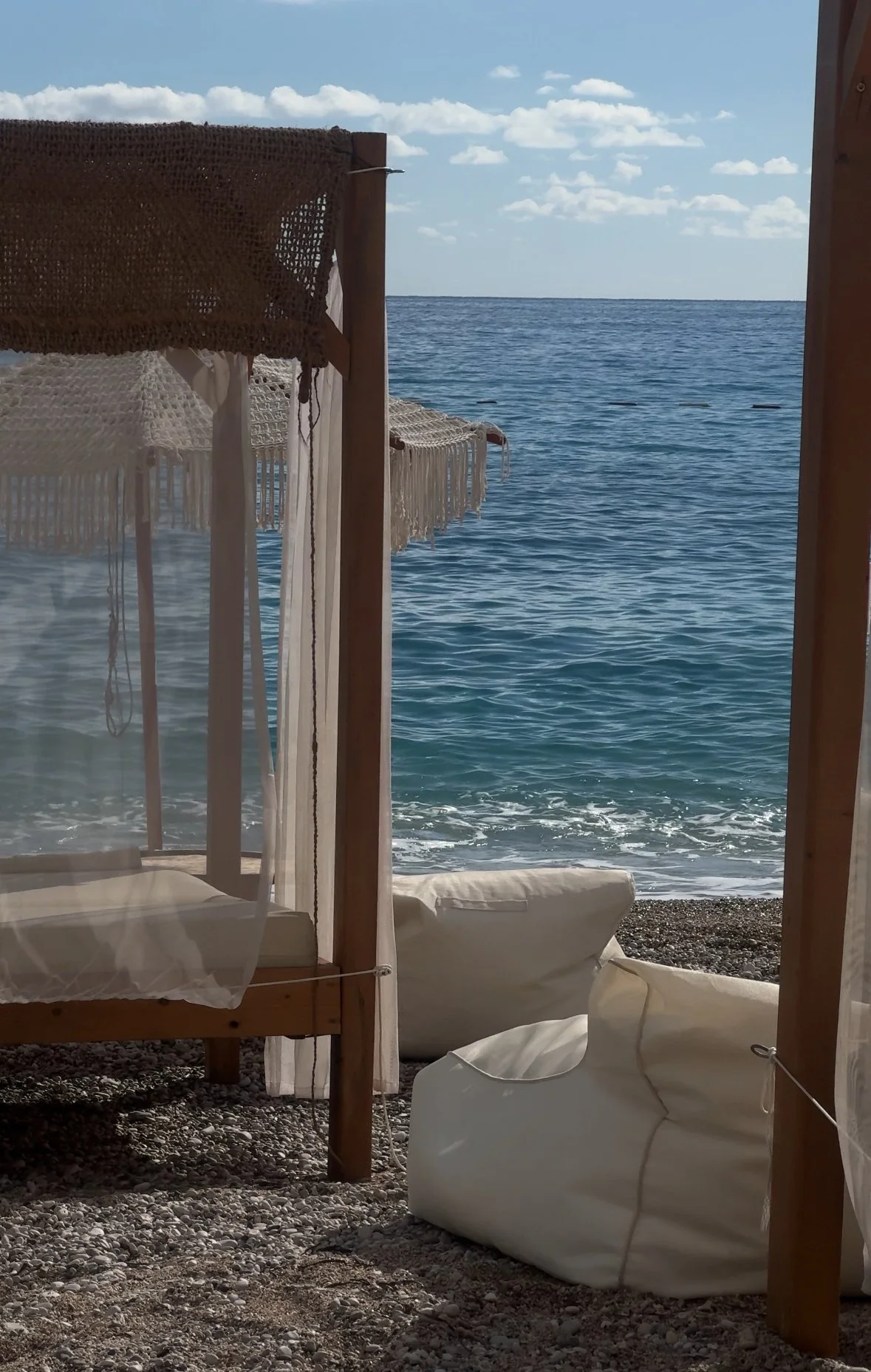 Luxury beach cabana seating overlooking a calm ocean setting, captured for travel and hospitality social media content creation and destination marketing.