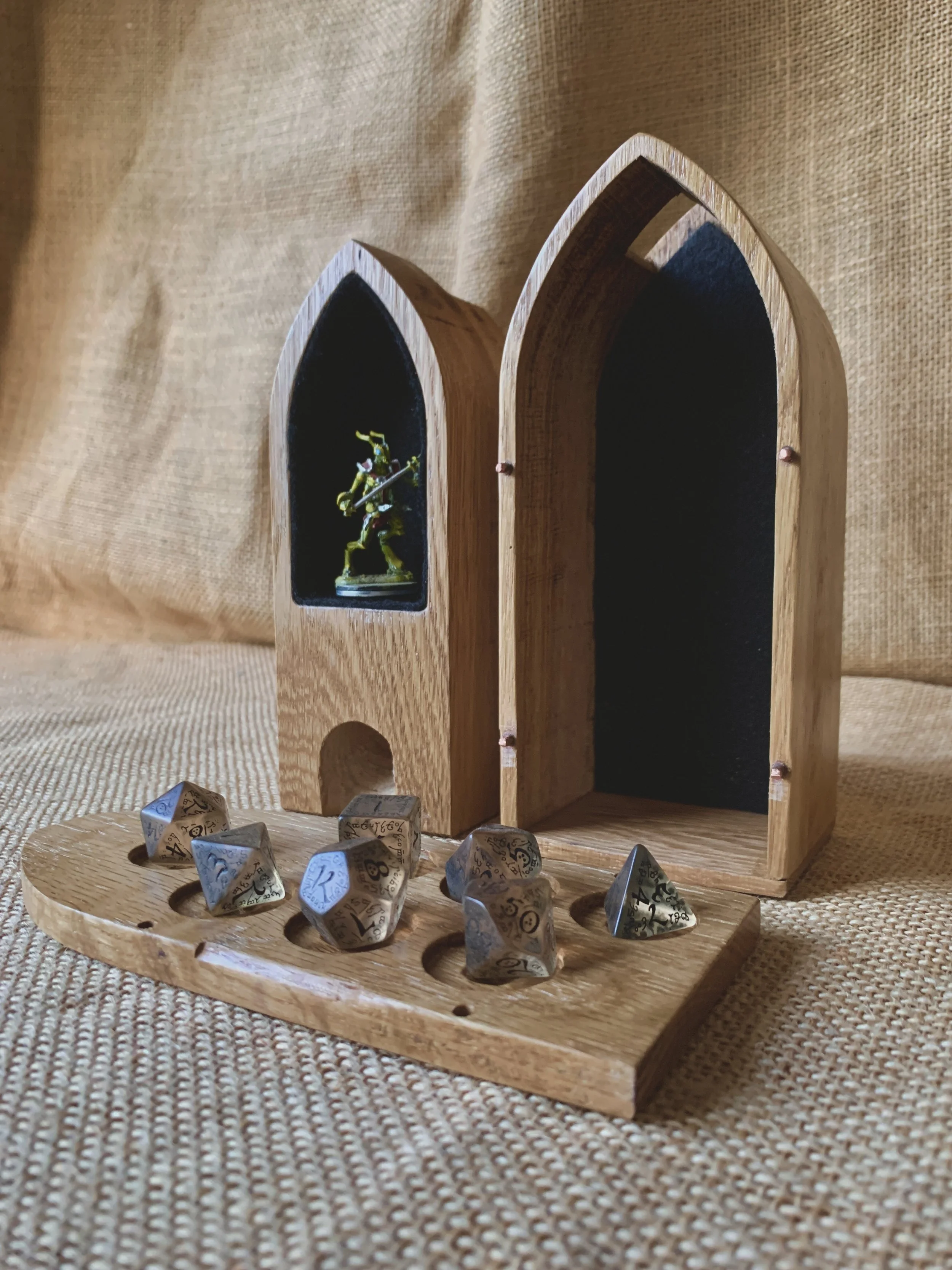 The box flips to become a dice tower and holds your mini in a felt lined box