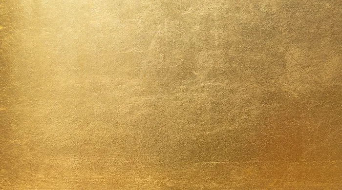 Detail of a textured gold metallic surface metallic.